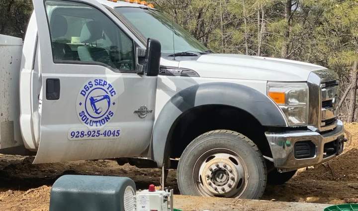 Branded D&S service truck at a septic job site