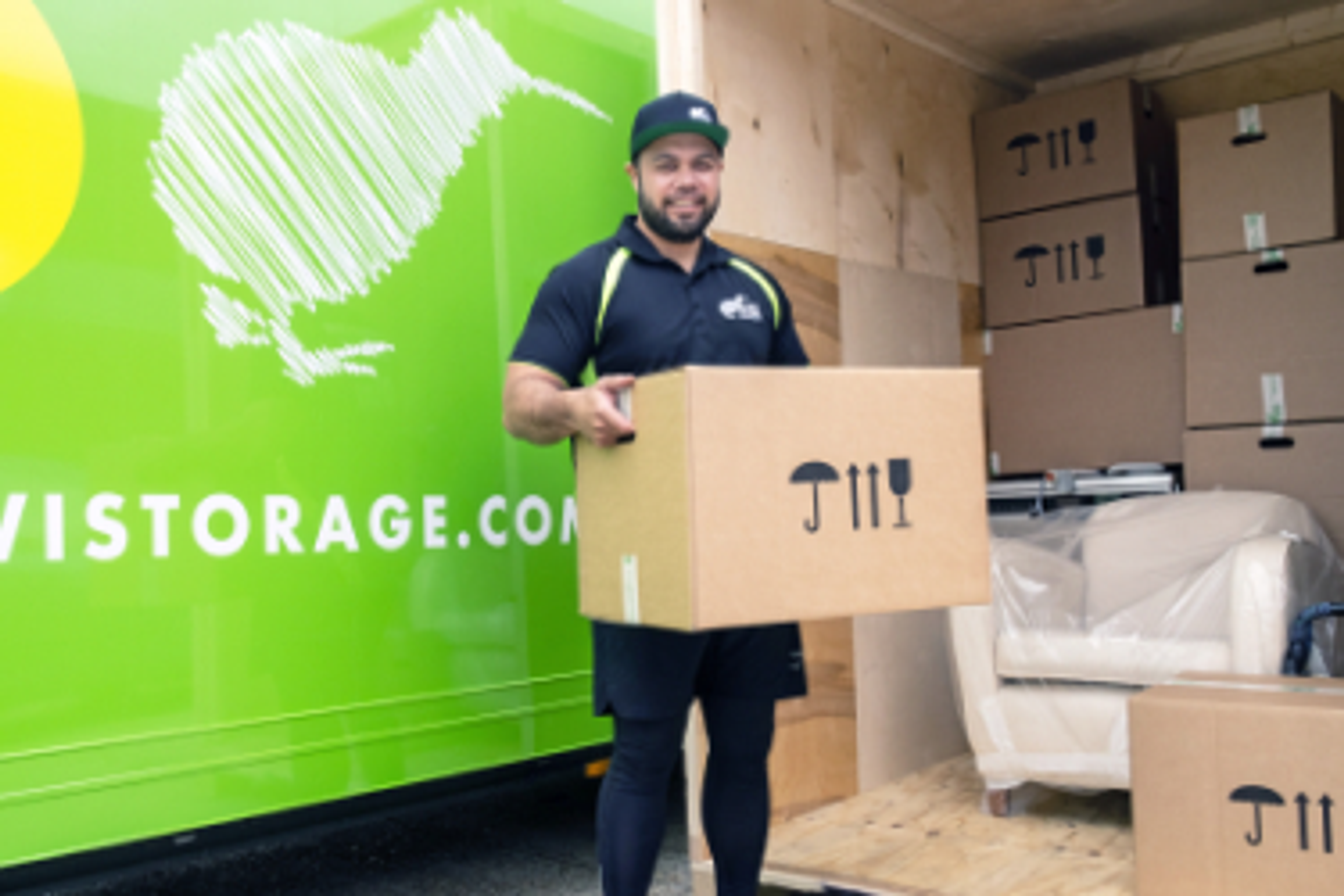 kiwi worker carrying a box