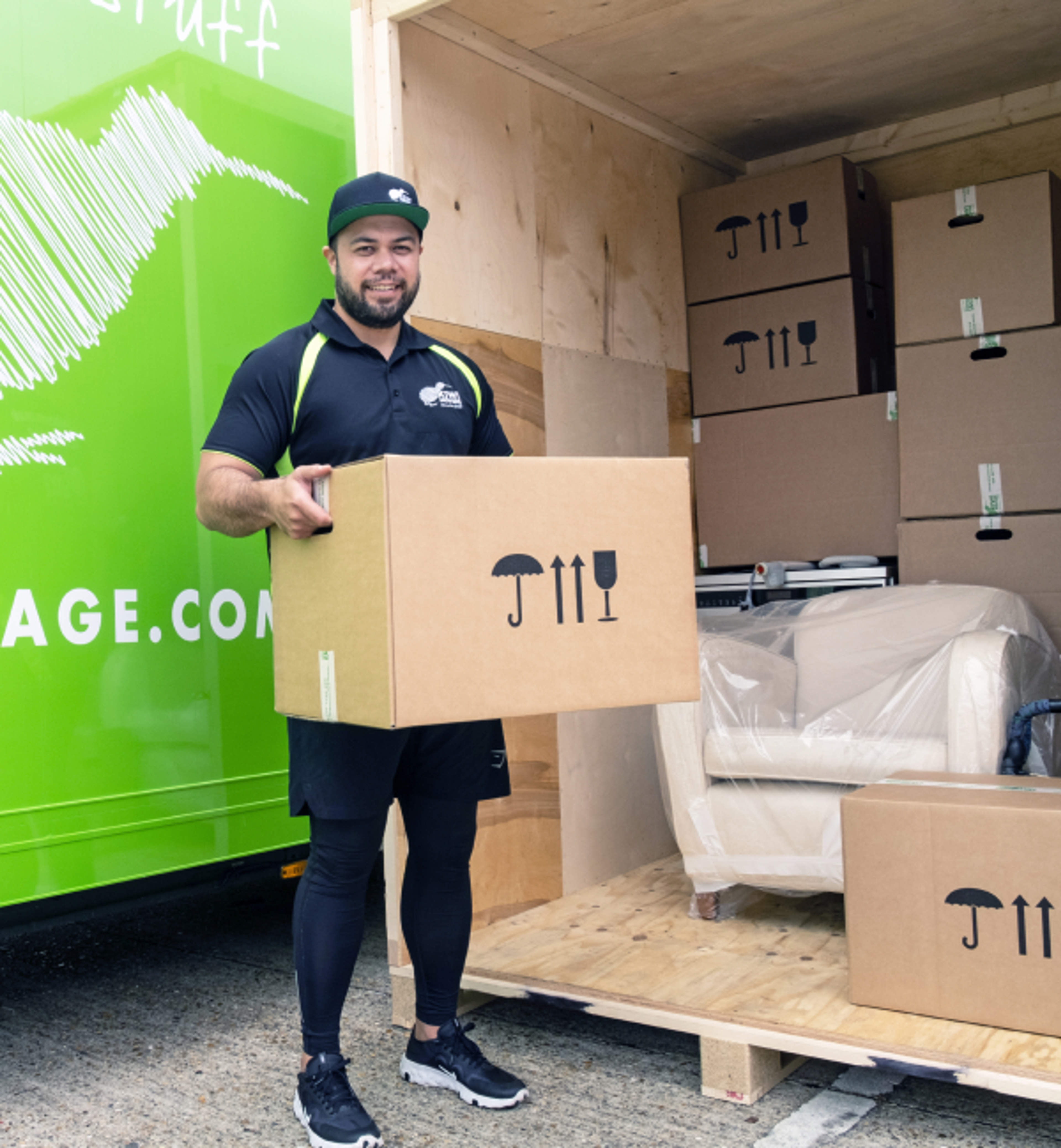 kiwi worker carrying a box