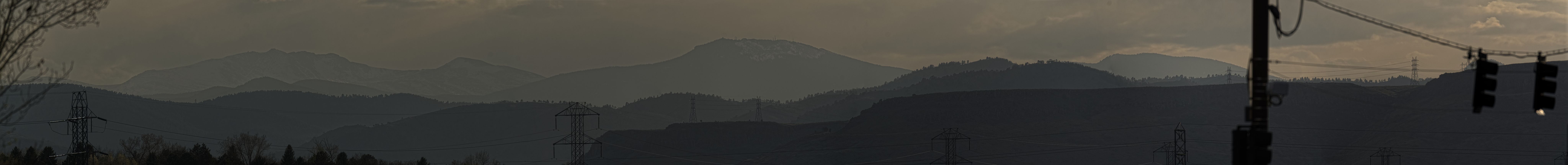 A panorama of some mountains at sunset