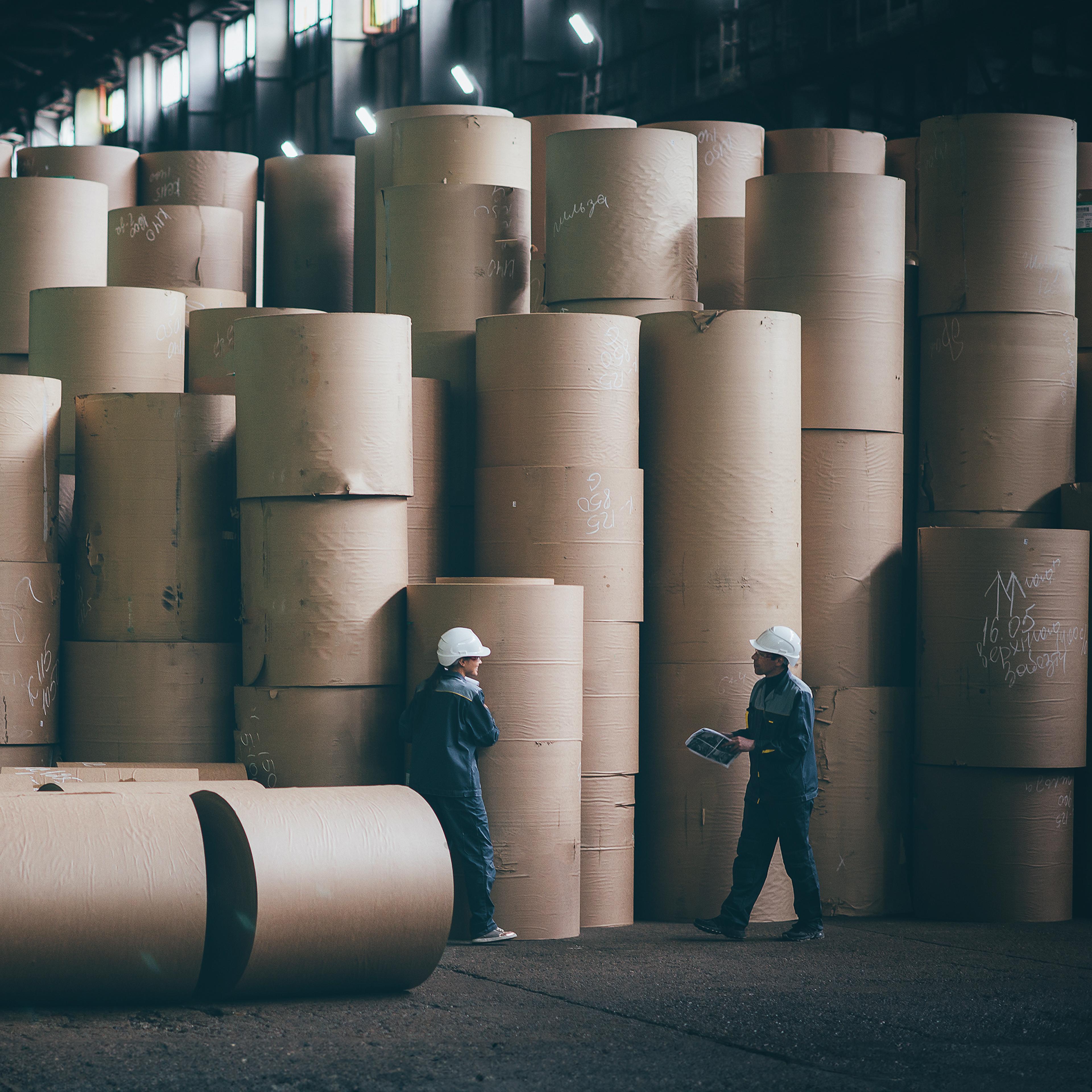 Paper rolls in a storage, 2 persons