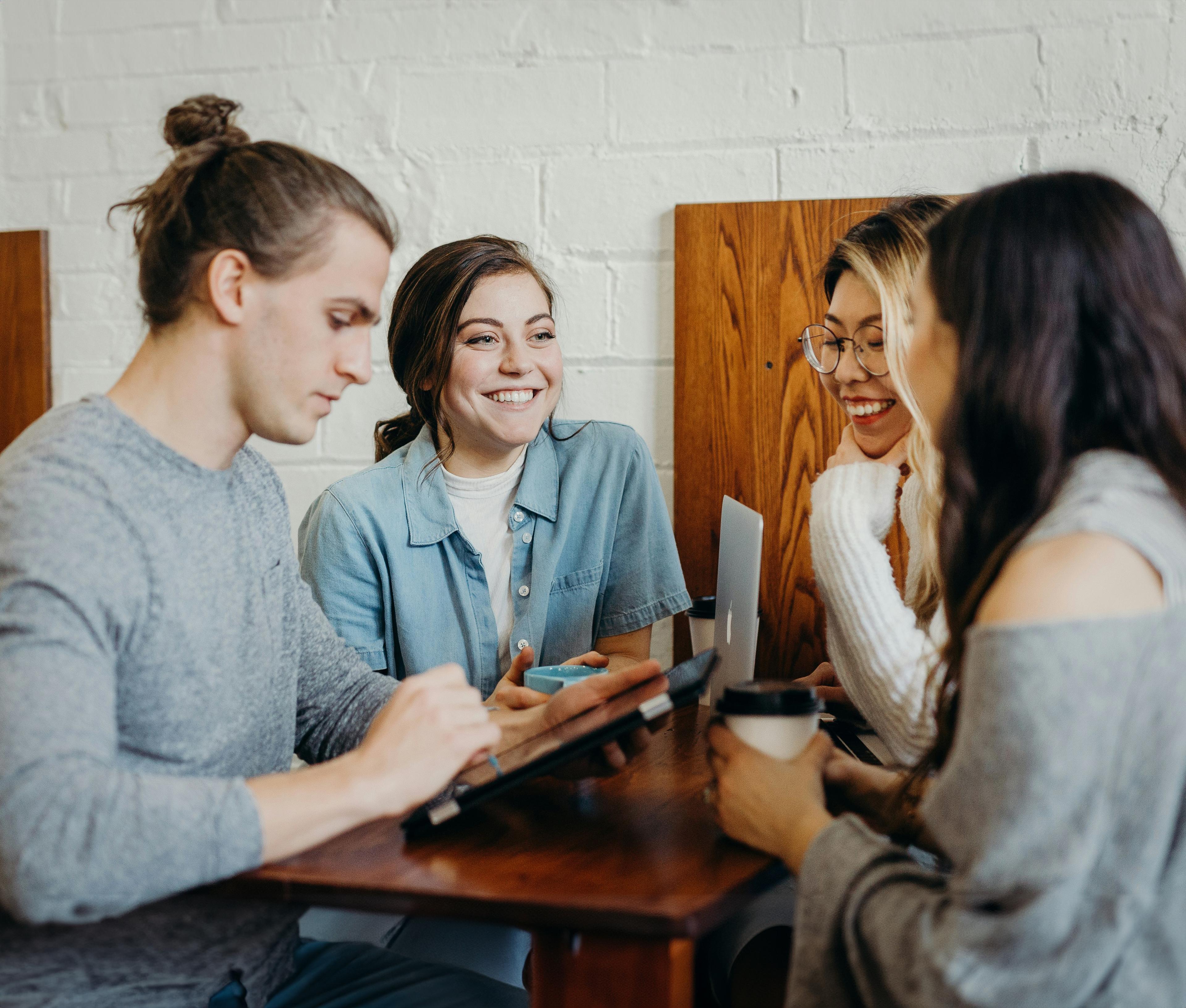 4 people standing discussing