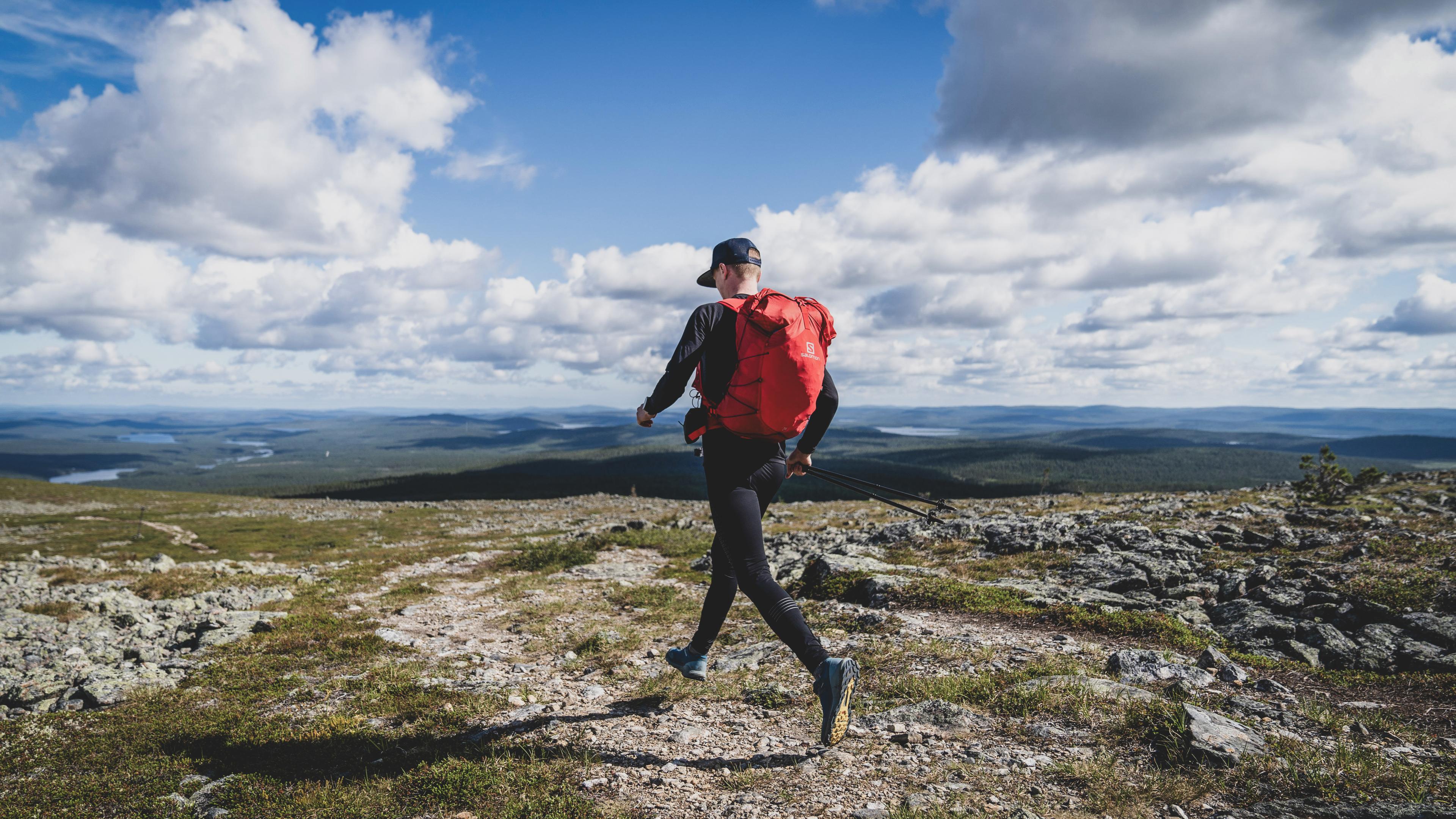 Man running with backpack in the mountains