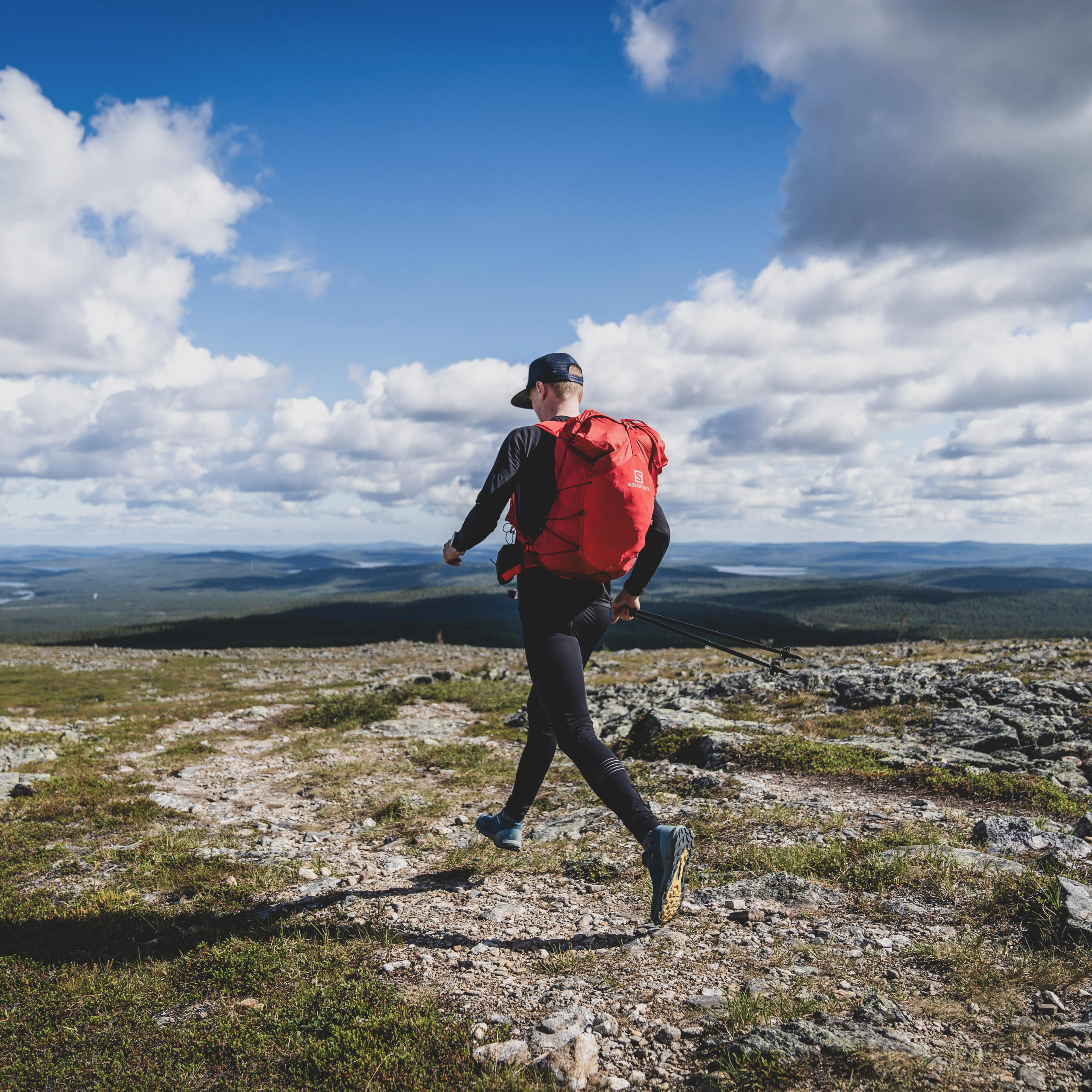 Man running with backpack in the mountains