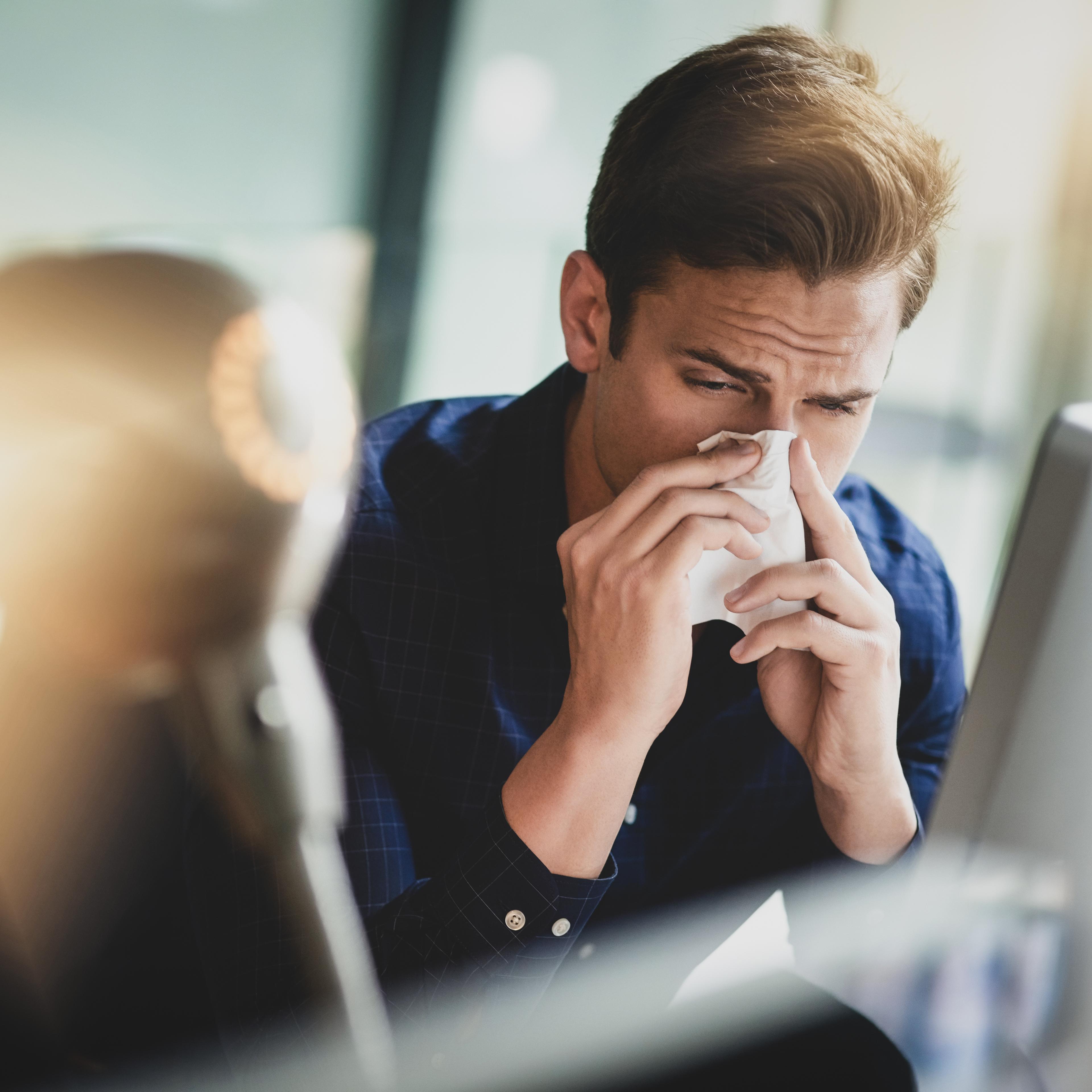 Man blowing his nose