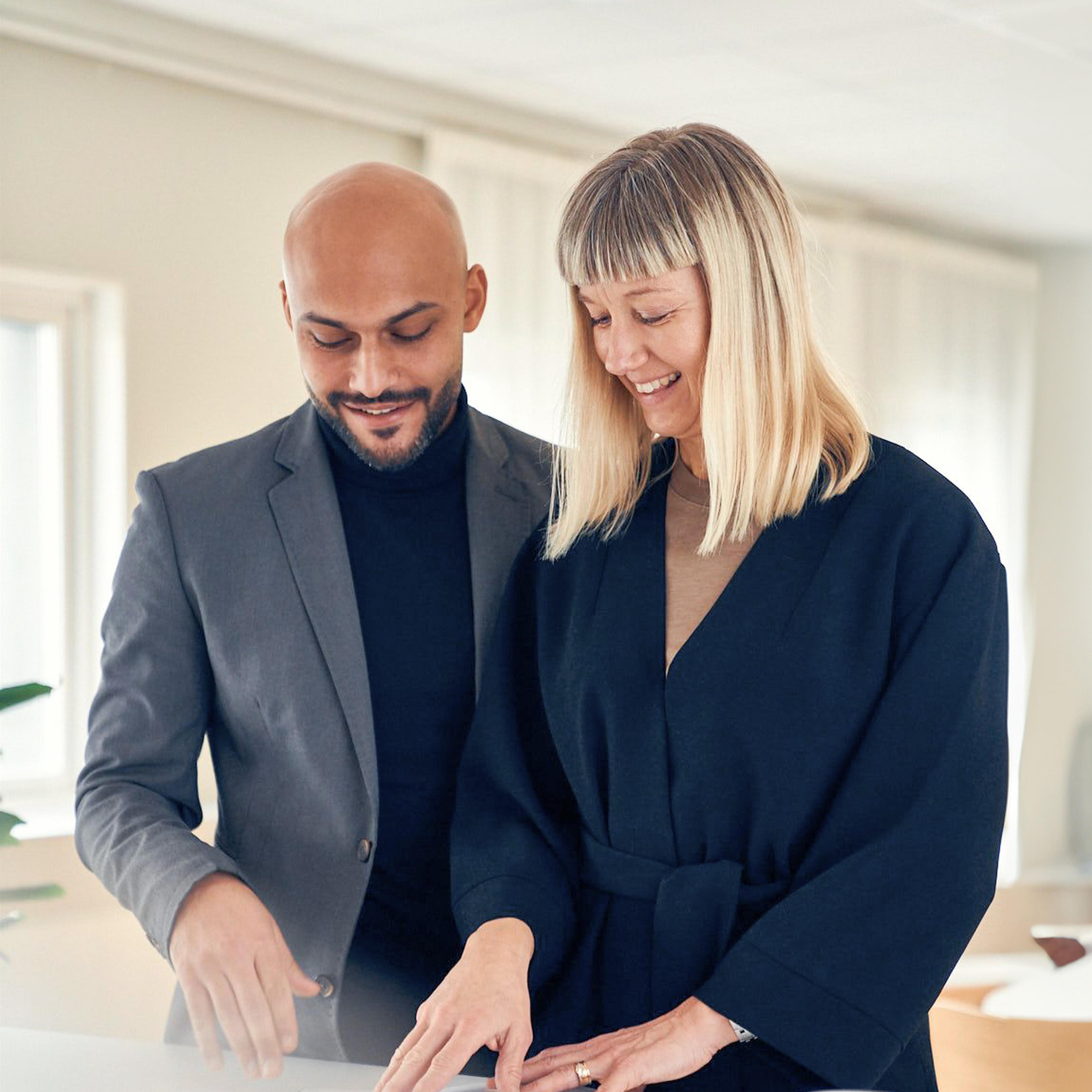 Man and woman looking in a document together