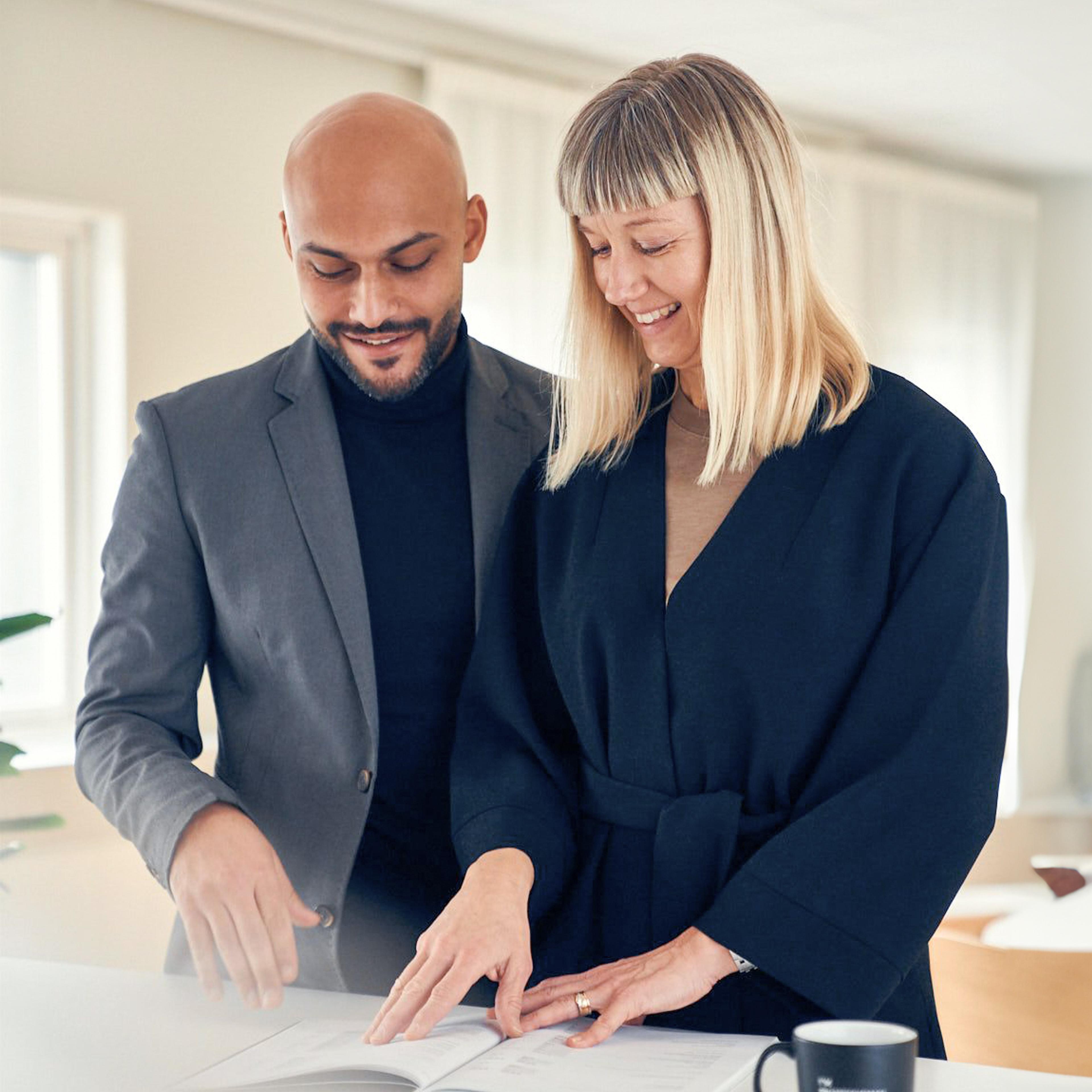 Man and woman looking in a document together