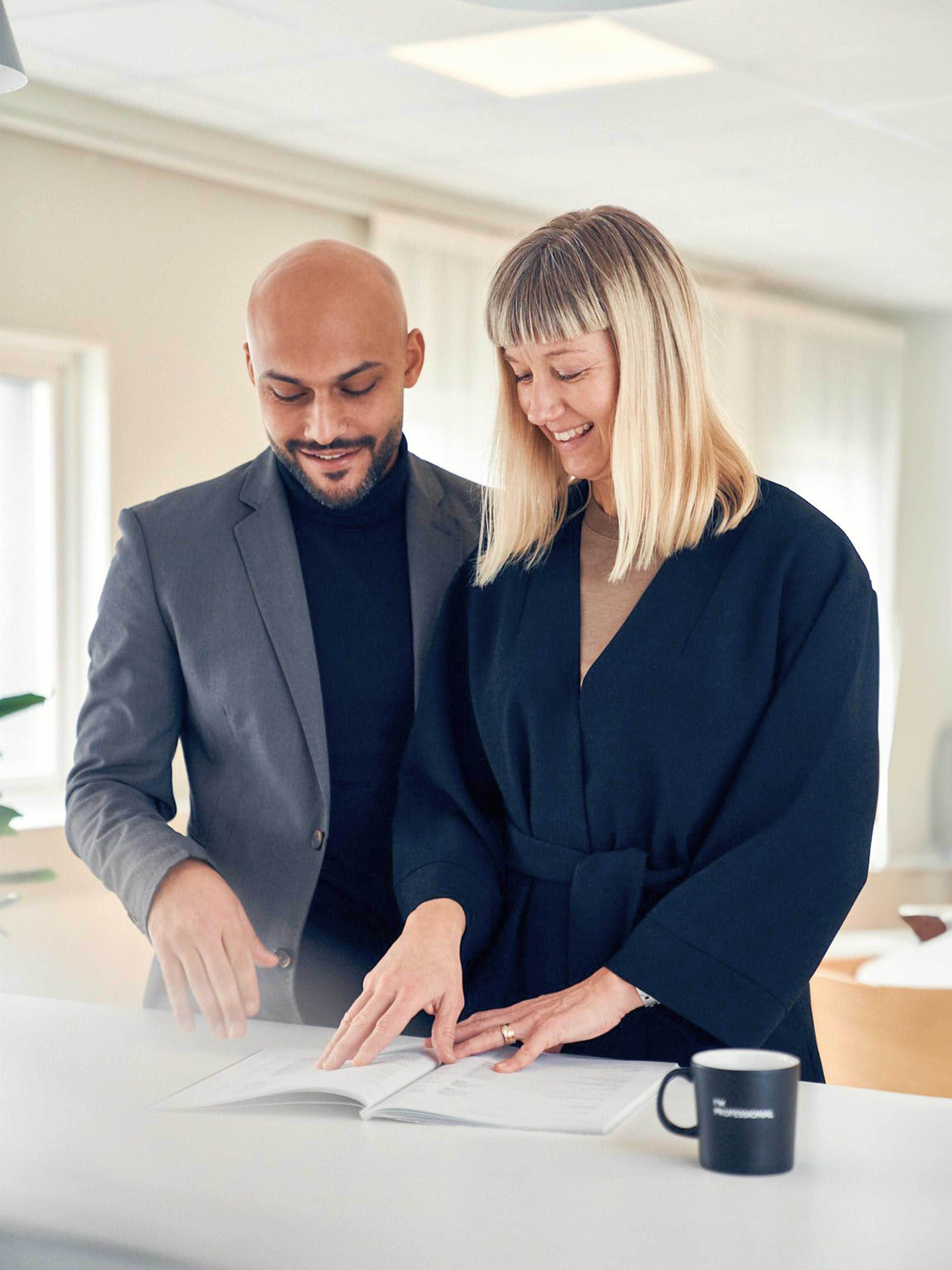 Man and woman looking in a document together