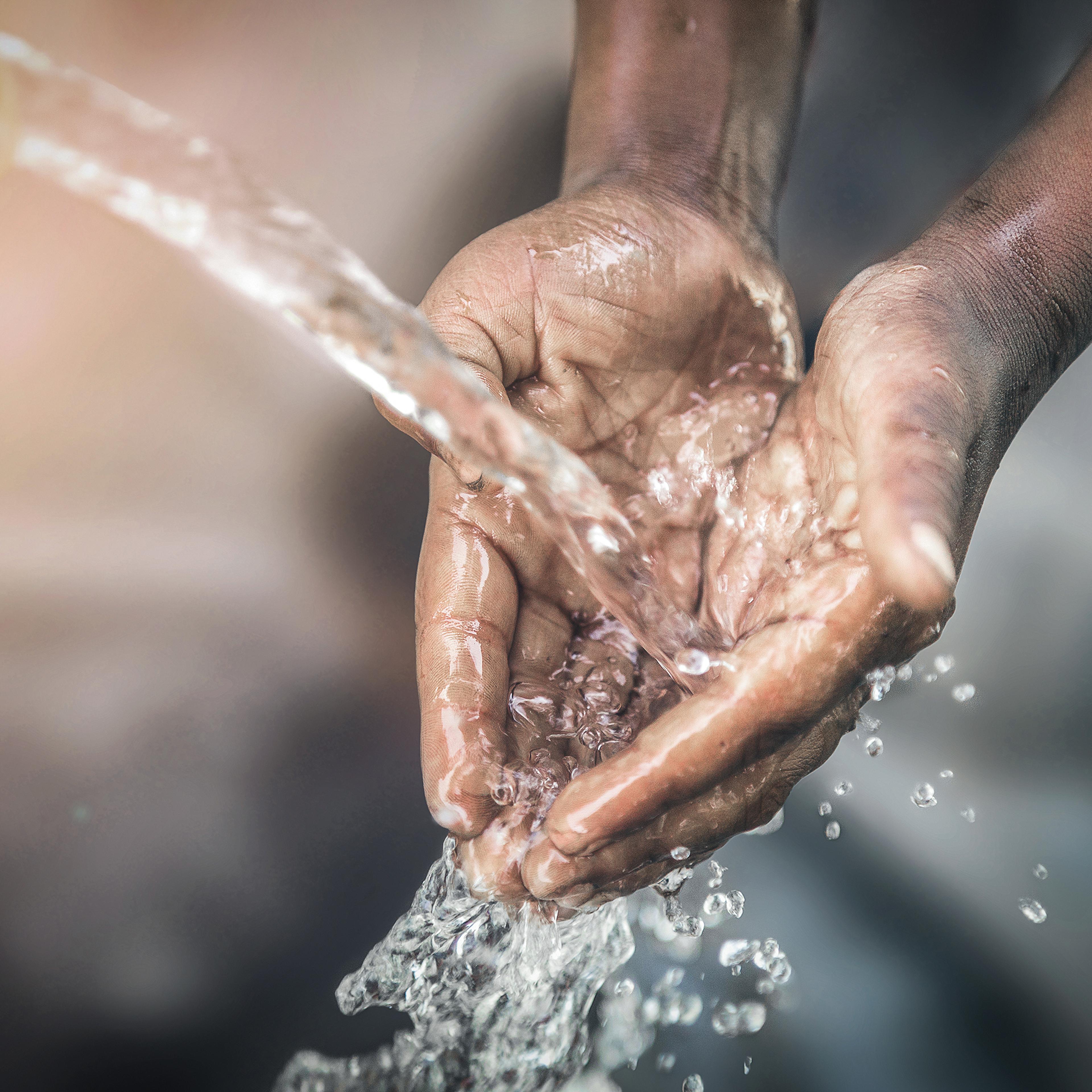 water flowing over hands
