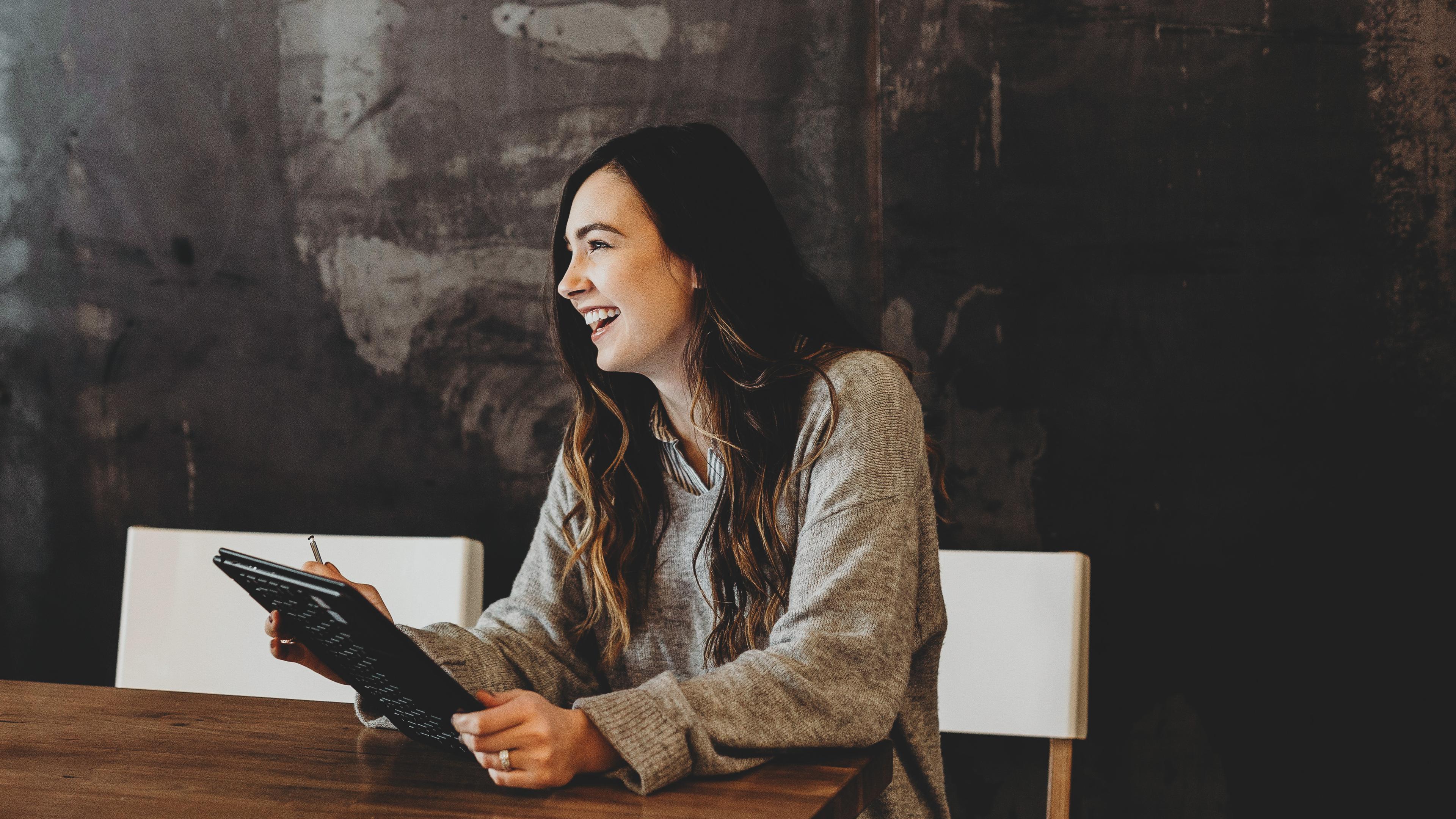 Woman sitting at a table with an ipad