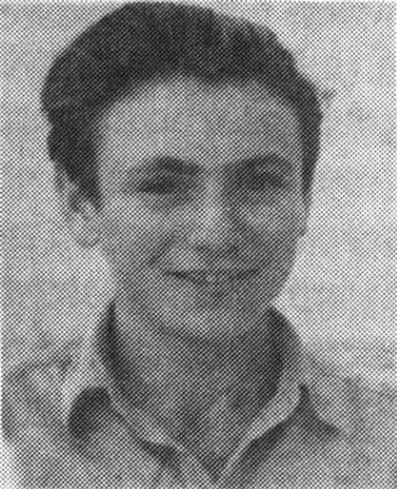 Photograph of a dark-haired adolescent young person.