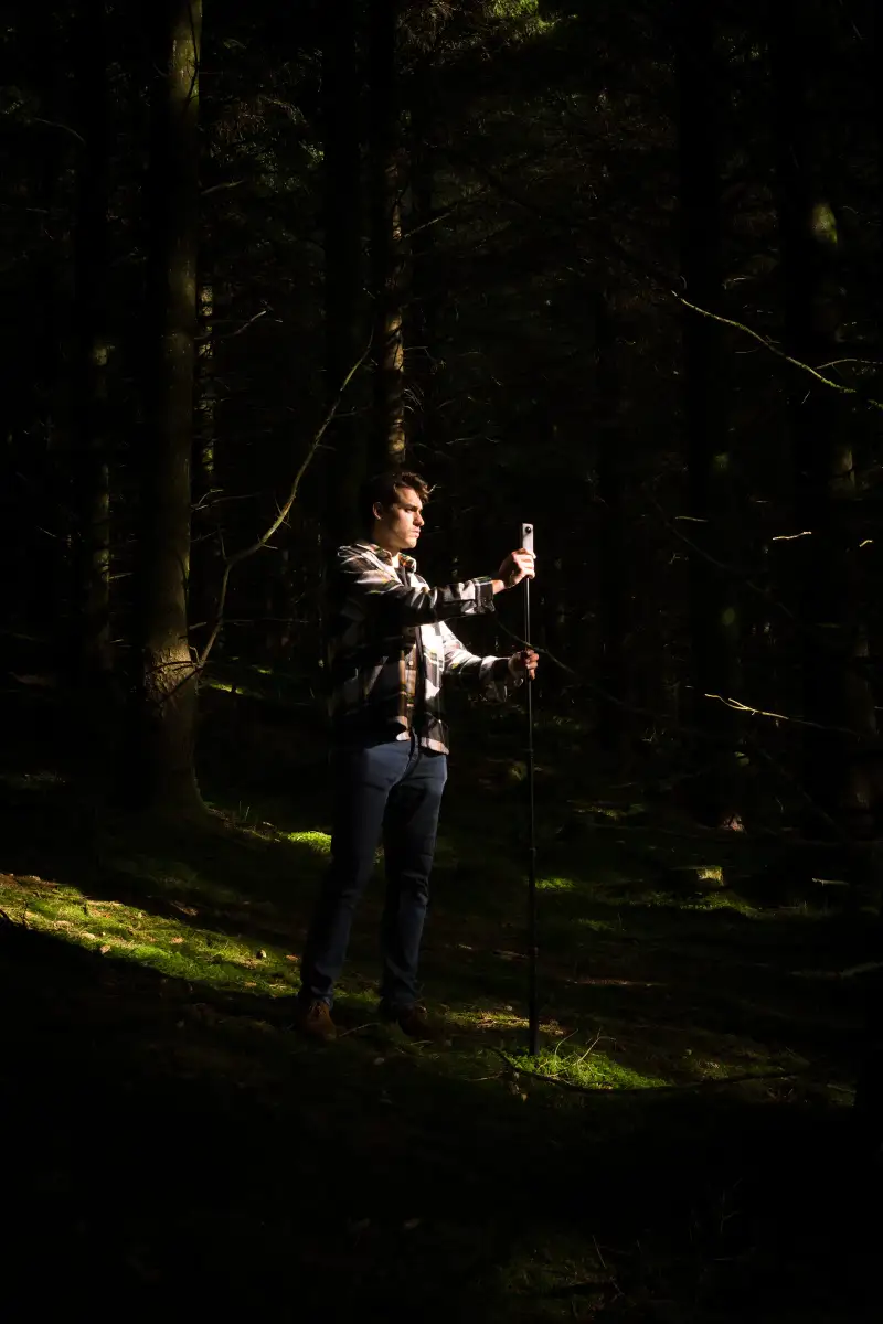 Mauri Martin recording with an Insta 360 camera in a Welsh forest
