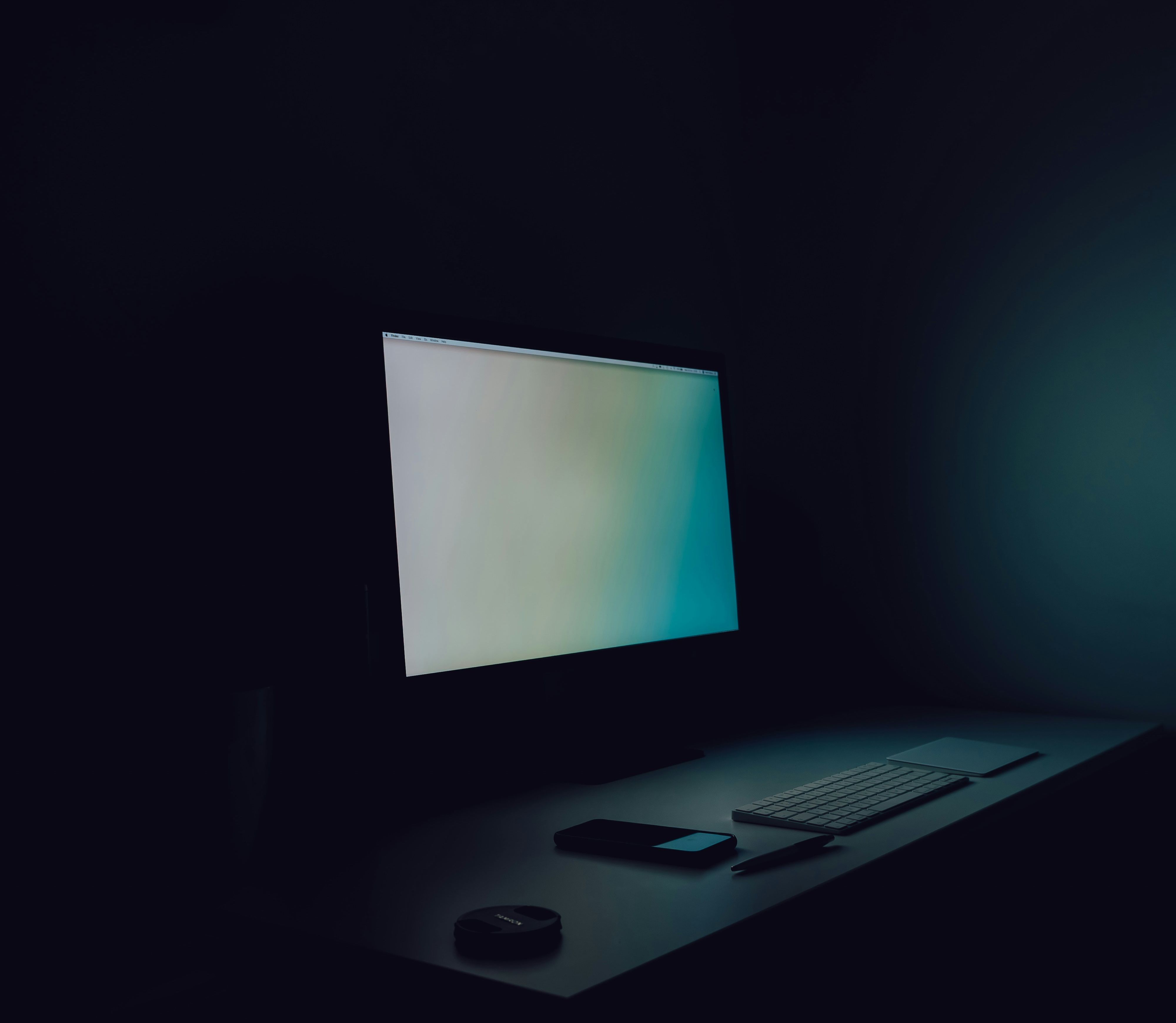 A computer left switched on and unattended in a dark office at night