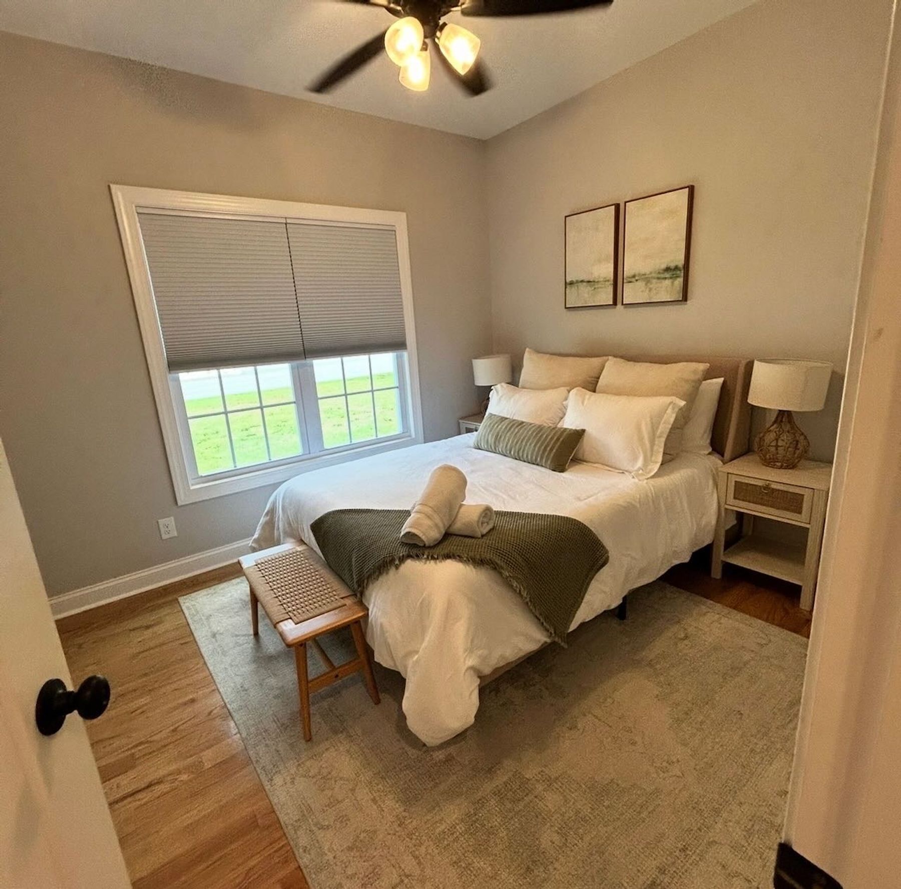 Guest-ready bedroom with made bed and folded towels, Amherst Virginia