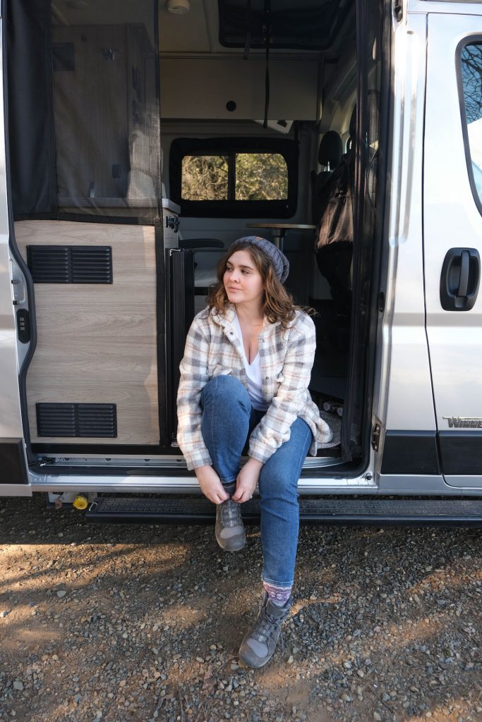 Jules of @julesjetsets in her rented campervan