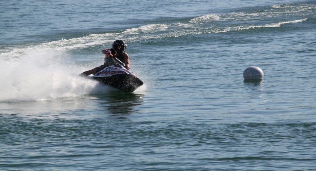 A jet ski racer rounds a buoy marker at speed on Lake Havasu in Lake Havasu City, Arizona