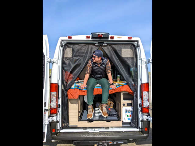 Bed at back of campervan rental