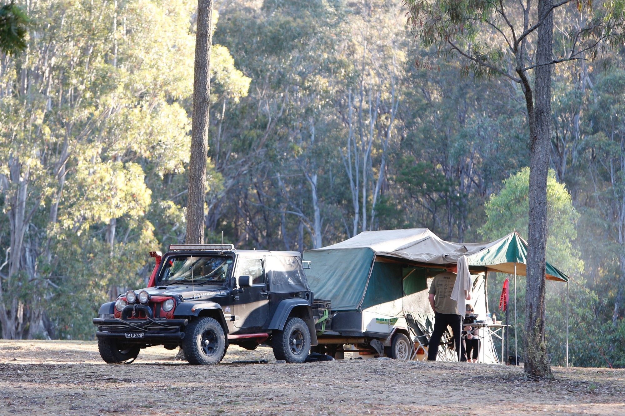 popup camper being towed by jeep