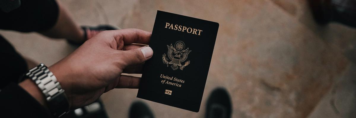 Hand holding passport from United States of America