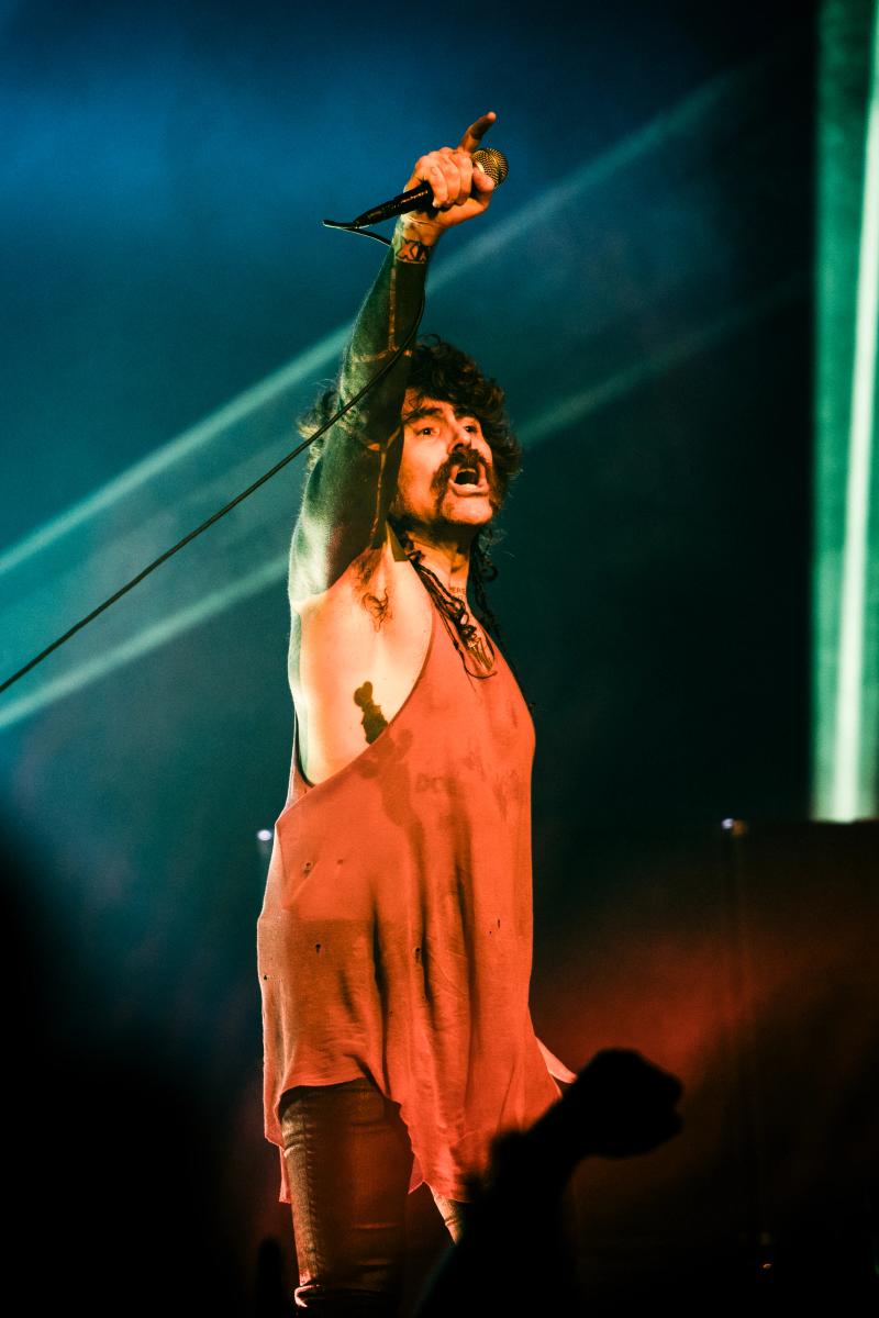 Davey Havok under a single spotlight