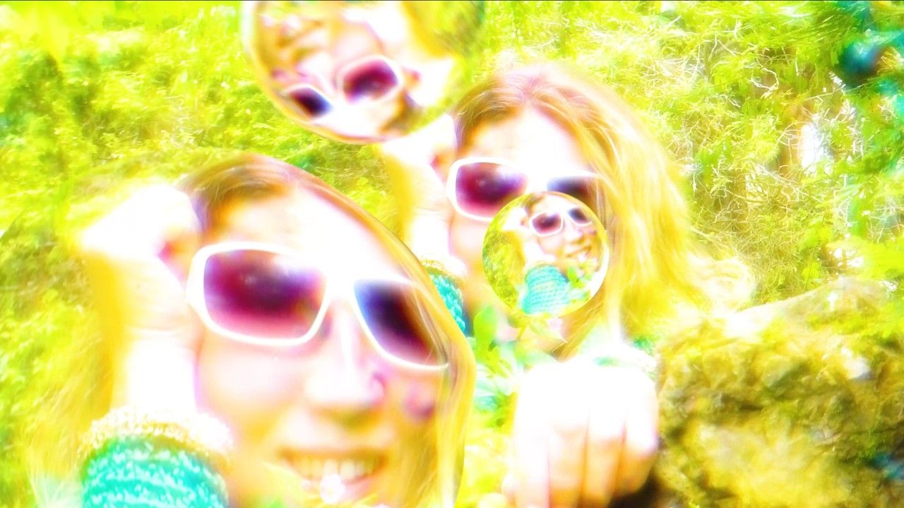No Joy Big Life, Big Leaf video image with a vivid blue figure against a bright green and yellow background.