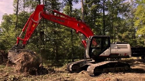 Link-Belt Excavators specialty machine working in a wooded area