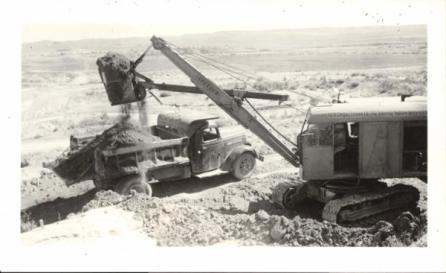 Historic photo of a Link-Belt machine dumping material into a truck