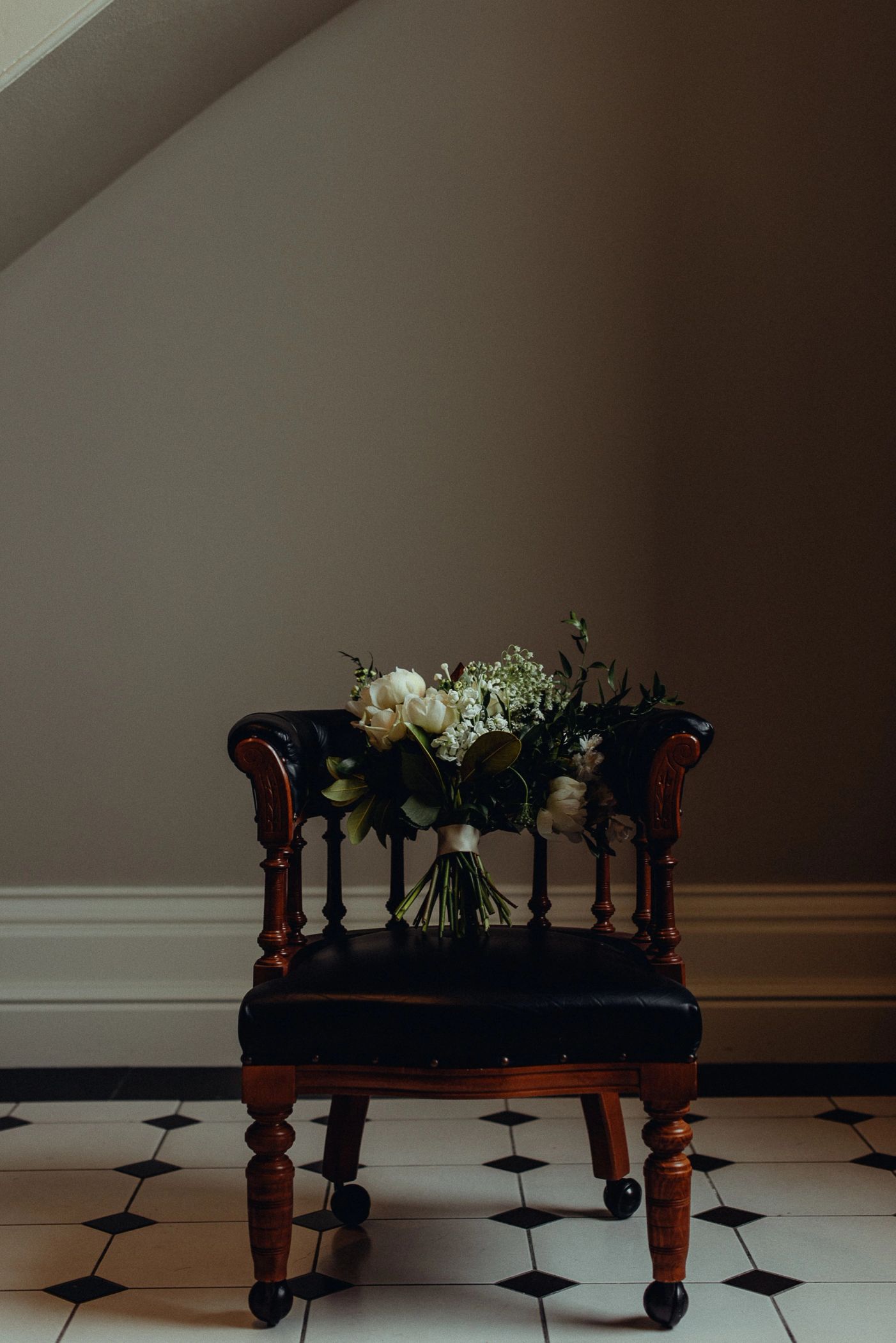 Wedding photography - chair with bridal floral arrangement