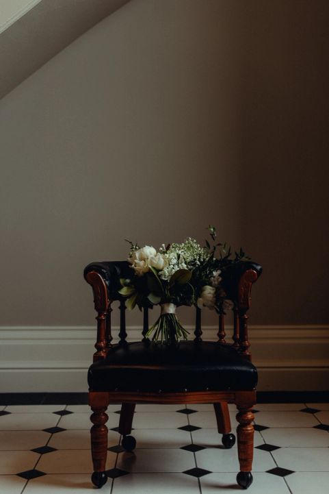 Wedding photography - chair with bridal floral arrangement