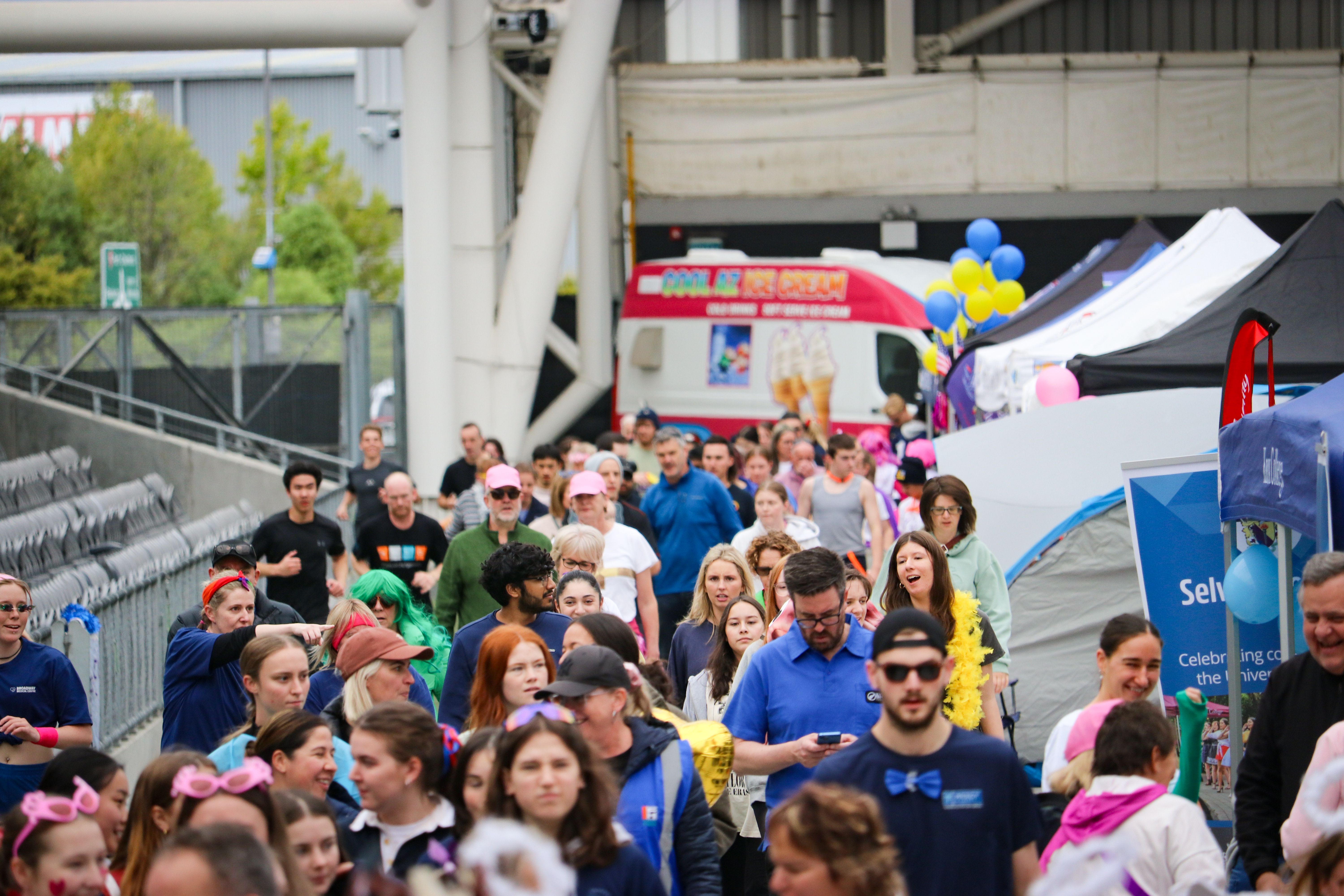 People walking around the Forsyth Barr Stadium at a community event