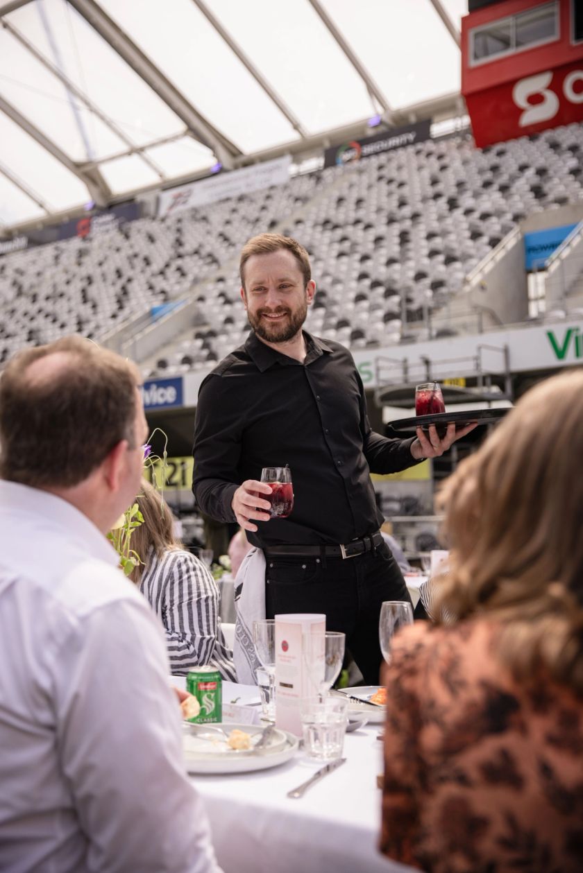 Man serving a drink at an event