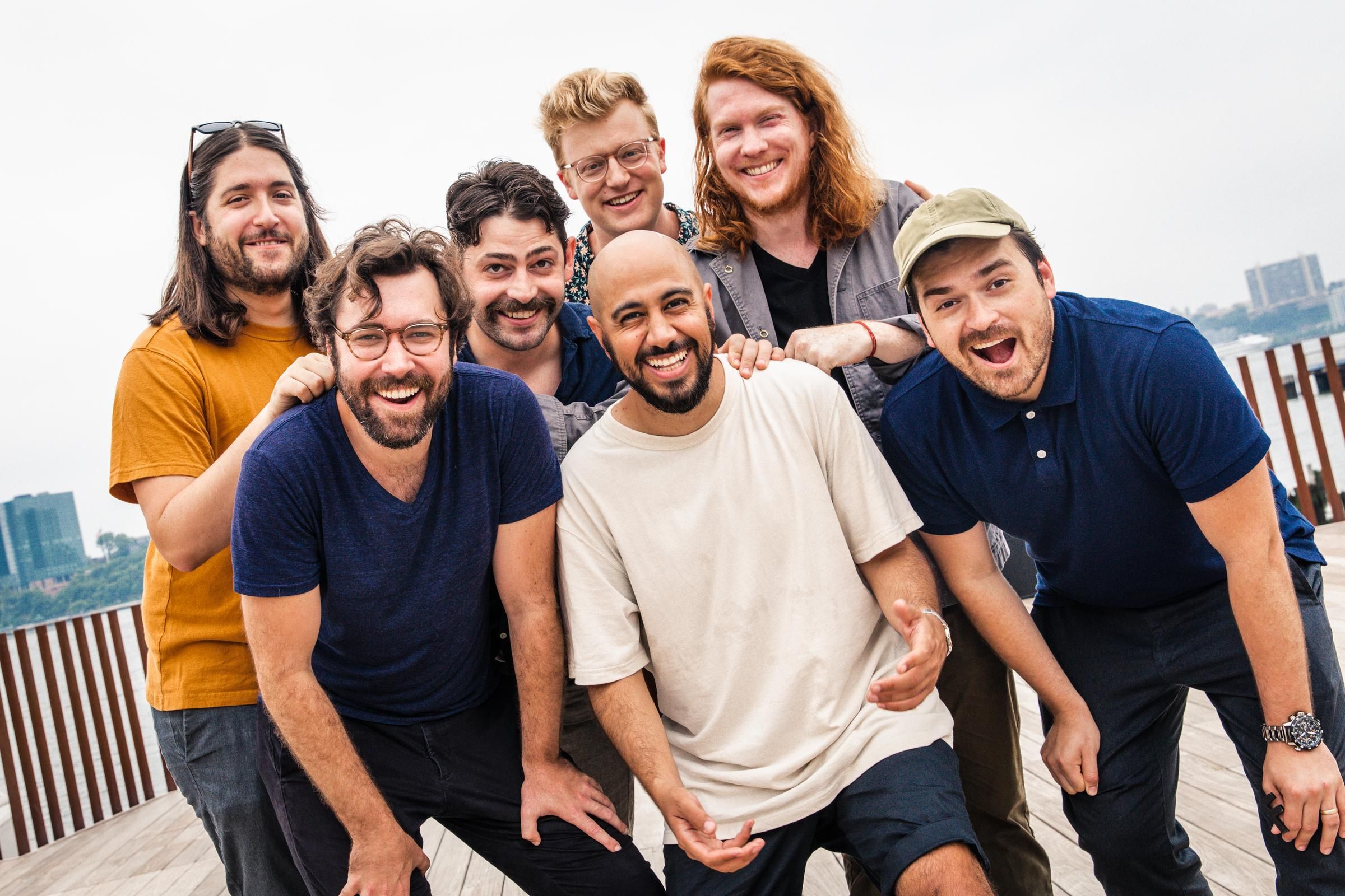 A photo of all seven members of PigPen Theatre Co.