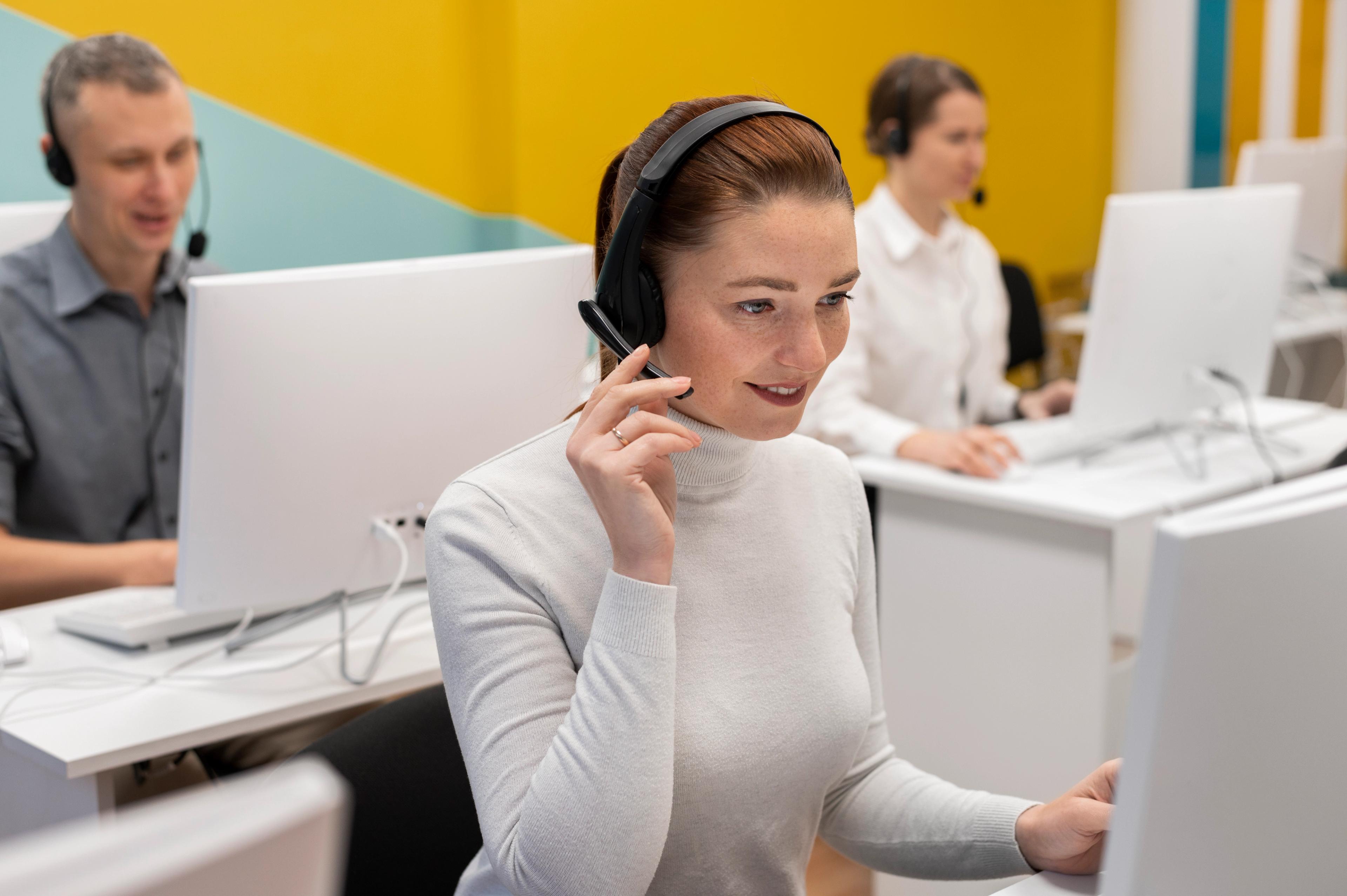 Employees providing customer support via computers and phone headsets