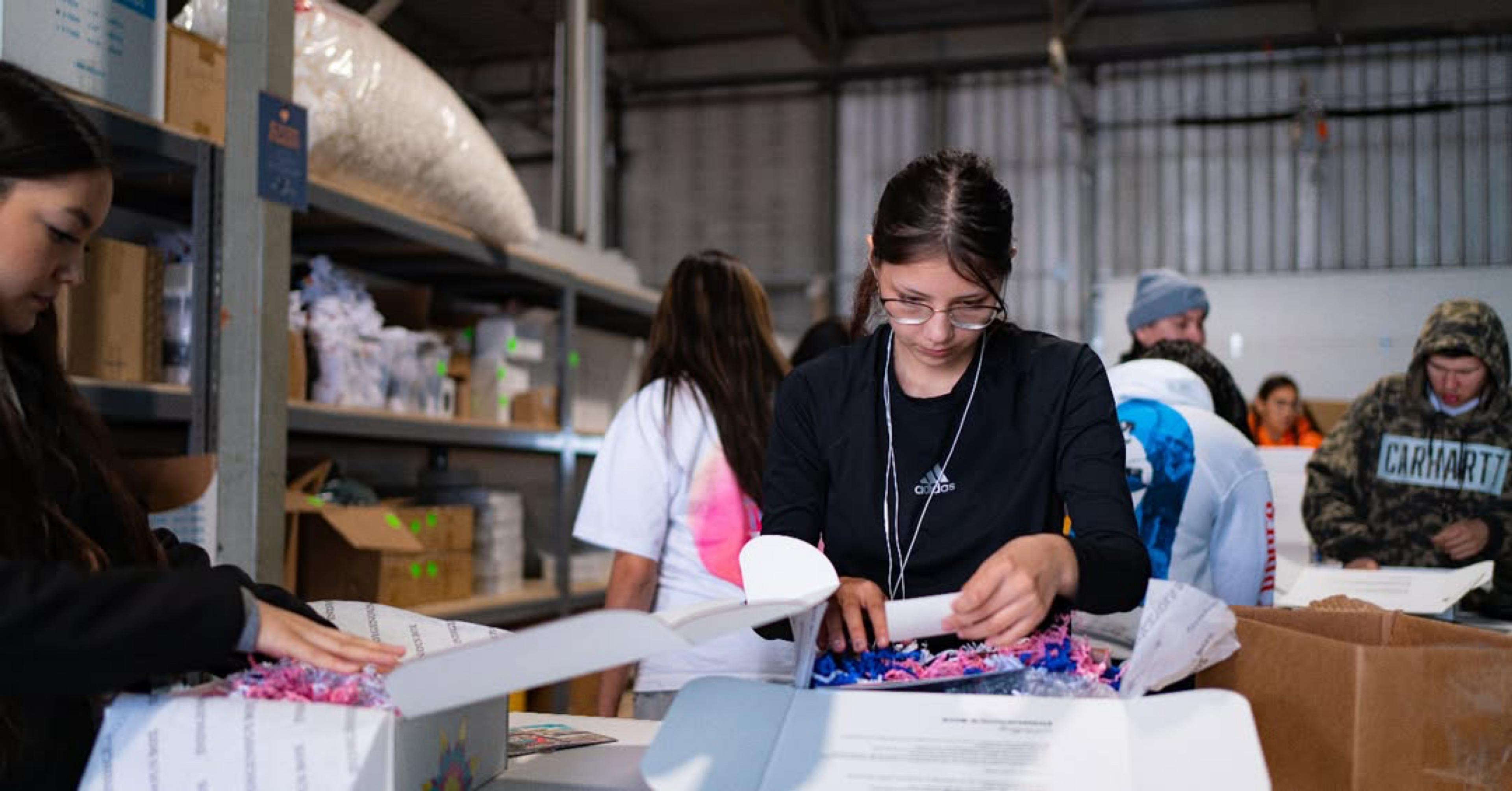 Team members packing goodies at the Indigenous Box warehouse