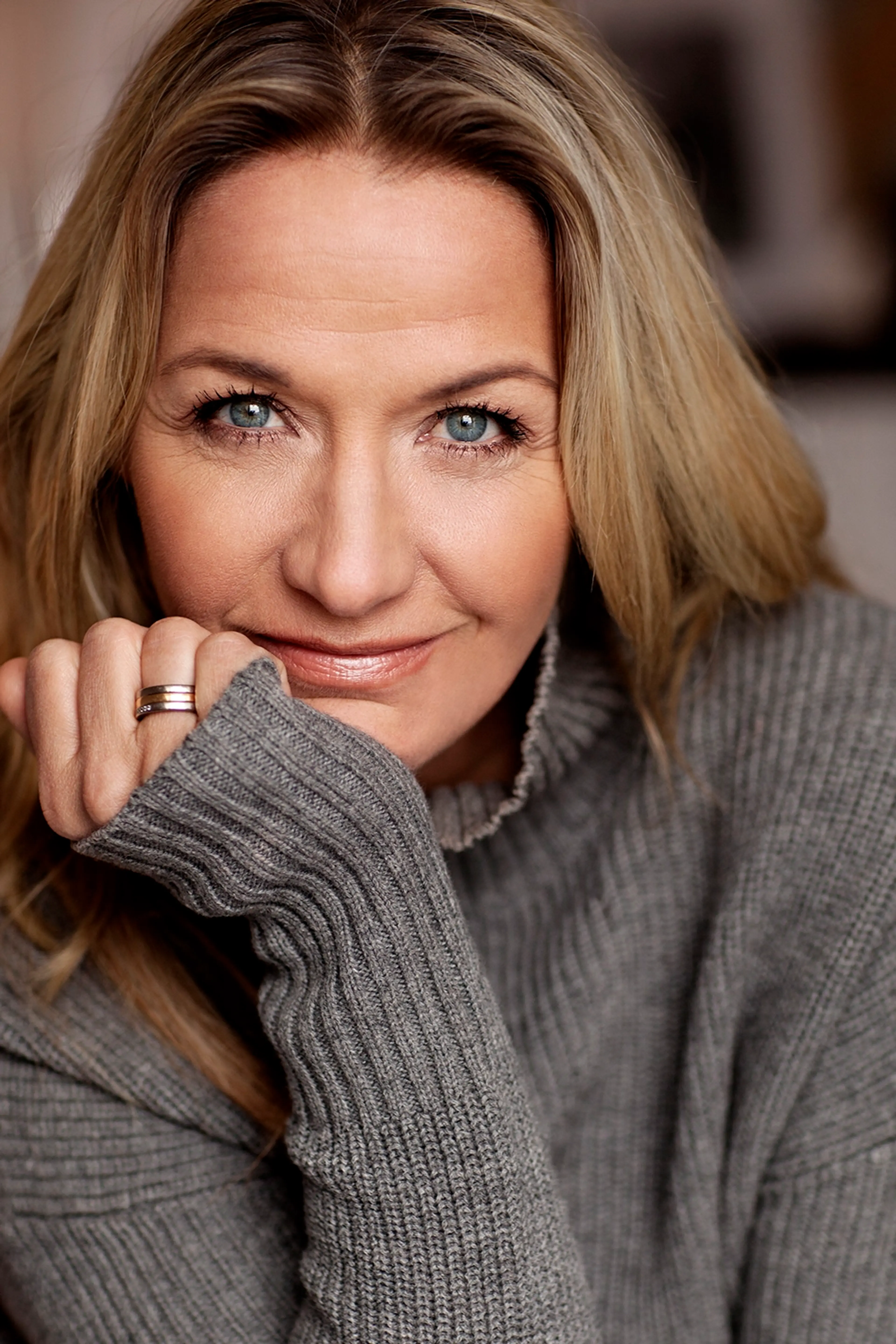 Kristin Kaspersen lutar hakan mot handen och tittar in i kameran