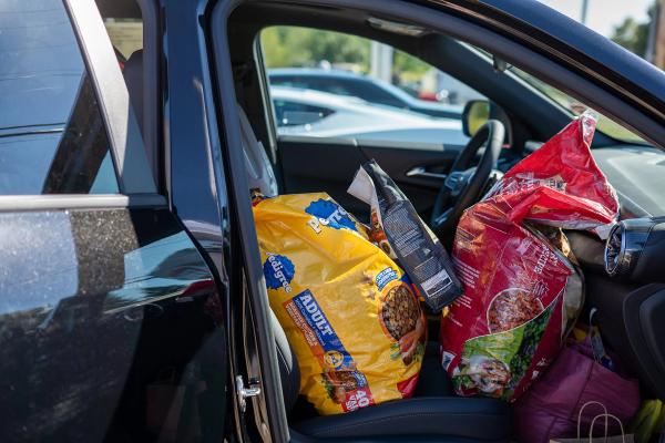 Chevy Equinox passenger seat loaded with pet food from donations. 