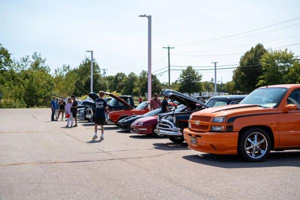 A row of cars and trucks at the show. 