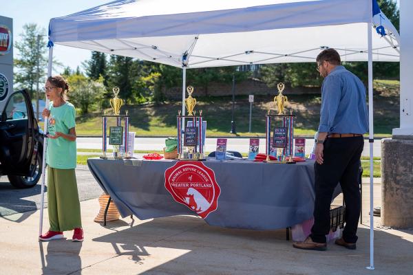 Donations table with trophies for car show winners. 