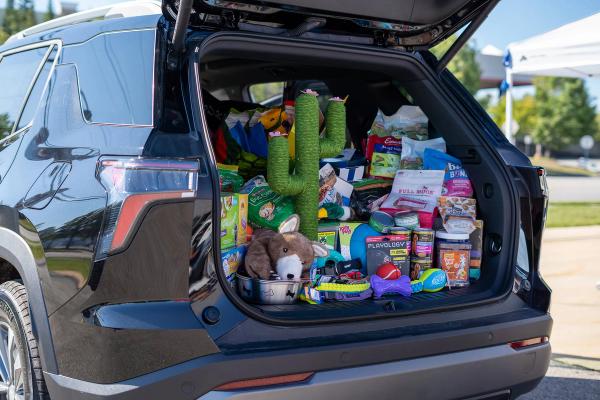 Chevy Equinox trunk filled with pet toys and food donations from the event.