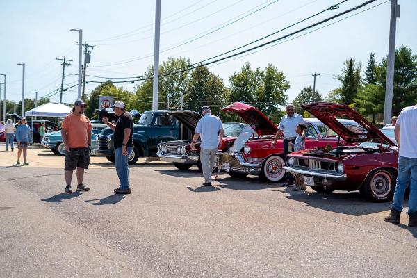 A line of antique cars and trucks at the show. 