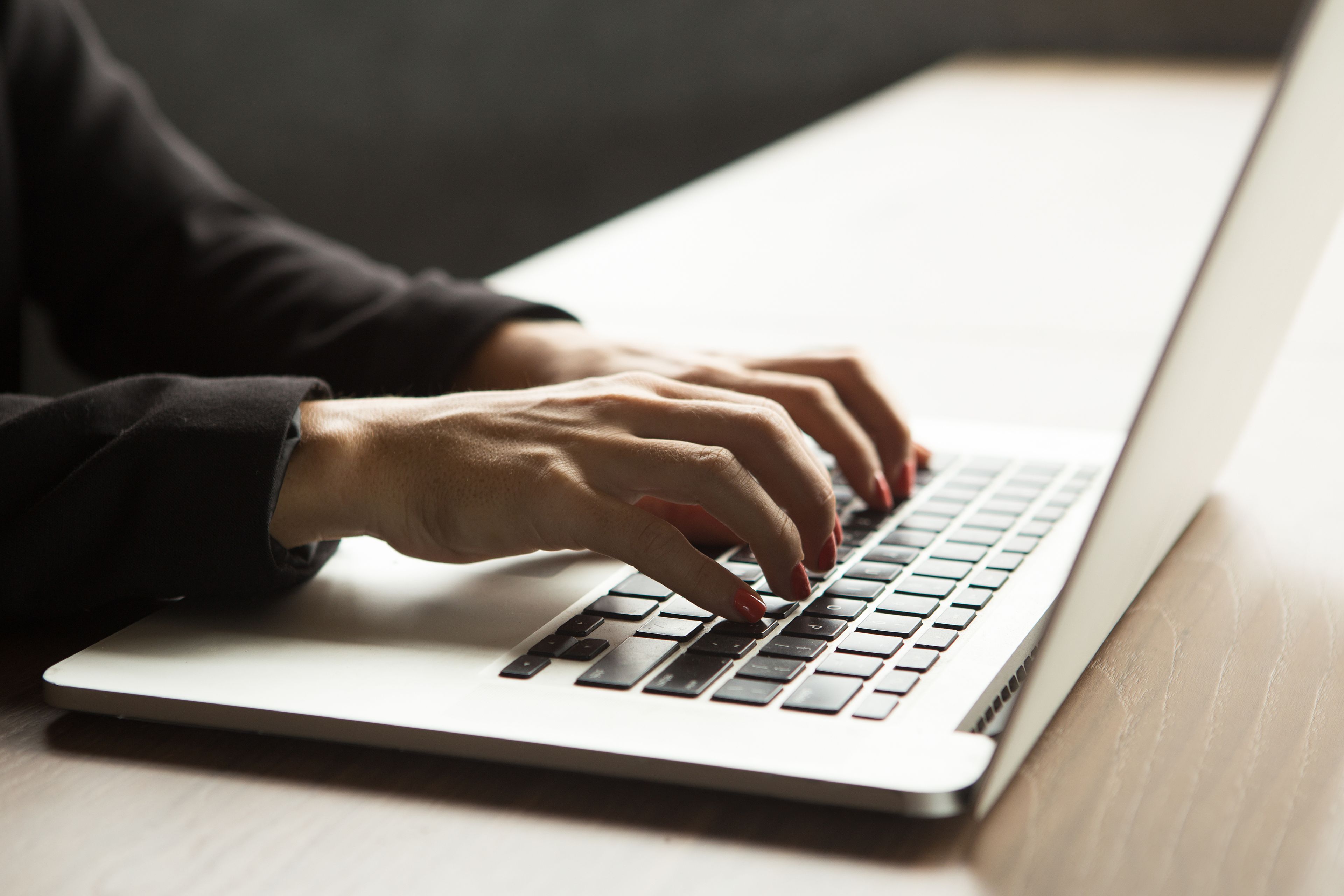 Close up image of woman typing