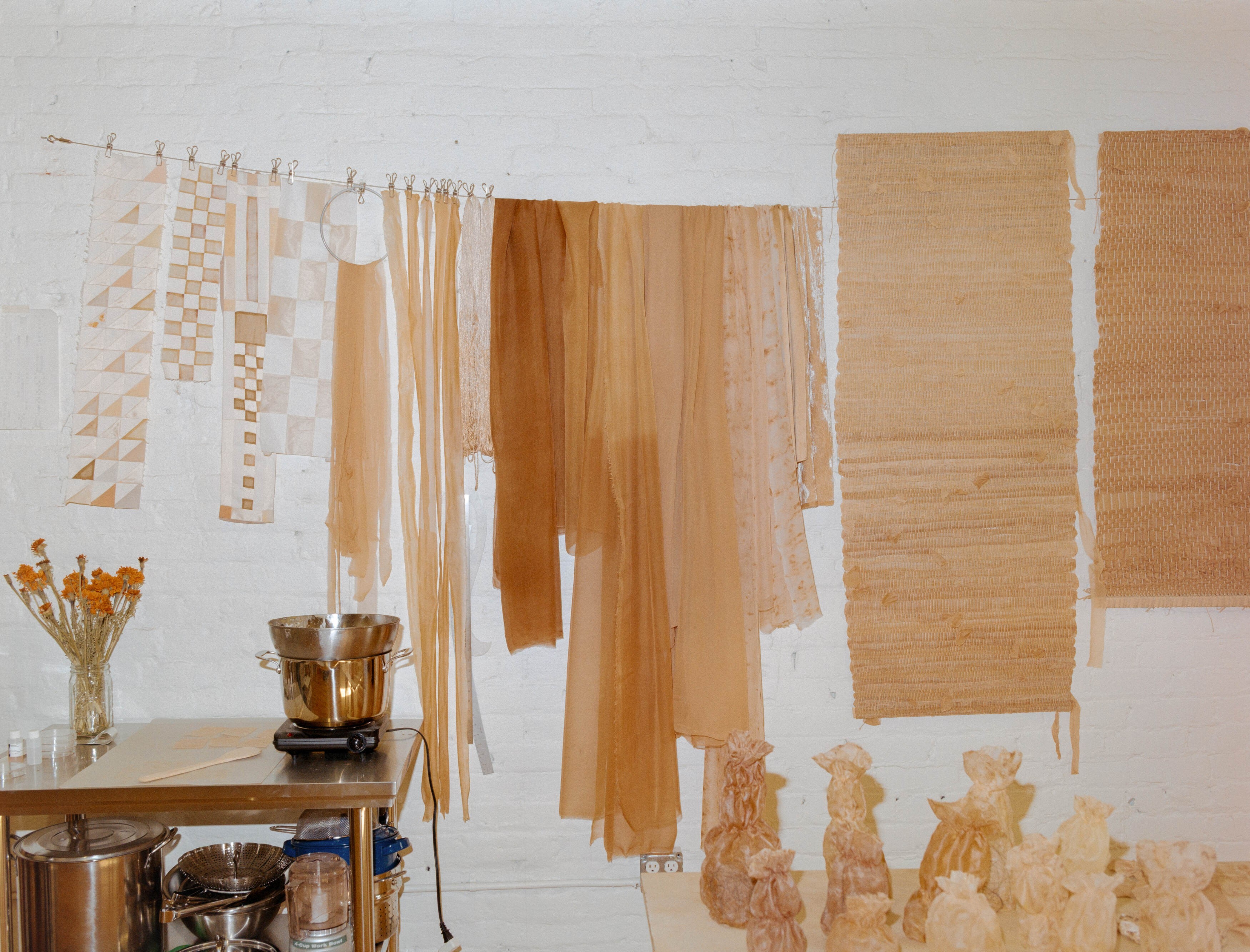 Naturally dyed textiles drying on a line above a dye pot in Laura Kung's Portland studio, shot on medium format film by Nathaniel Perales