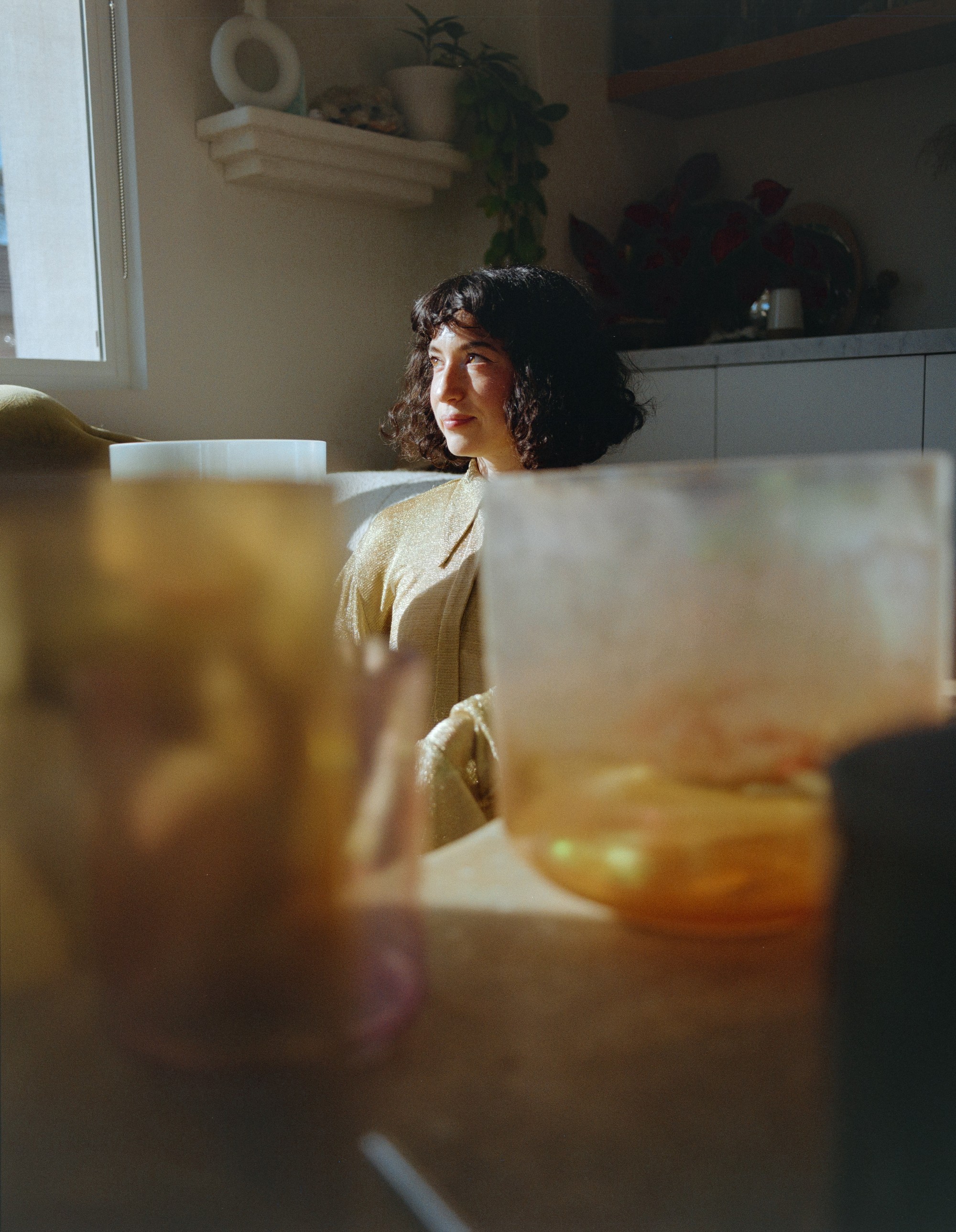 Portrait of Allison Bagg with crystal singing bowls in the foreground, Los Angeles, shot on 120 film by Nathaniel Perales