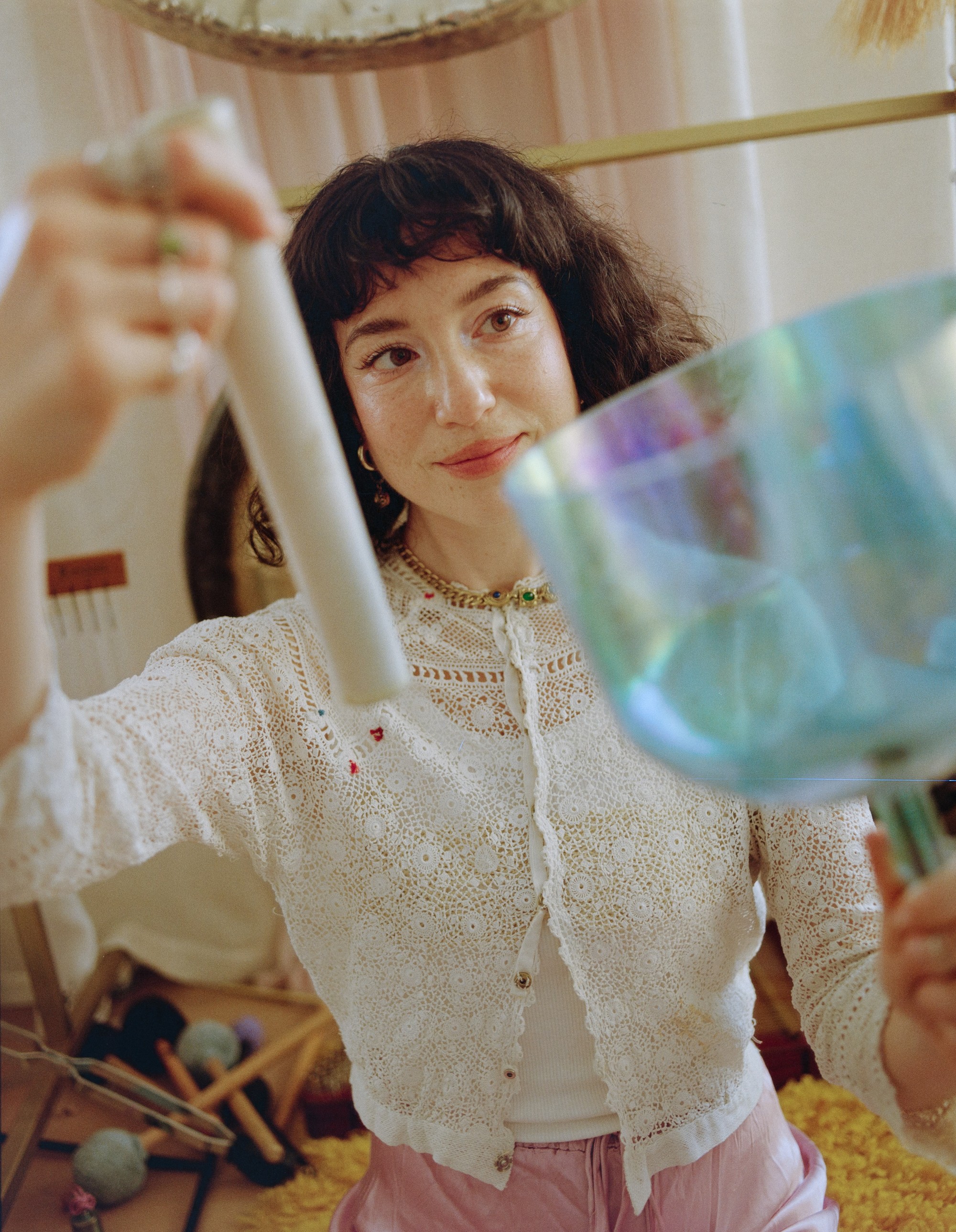 Close portrait of Allison Bagg holding a crystal singing bowl and mallet in her gong room, Los Angeles, medium format film by Nathaniel Perales