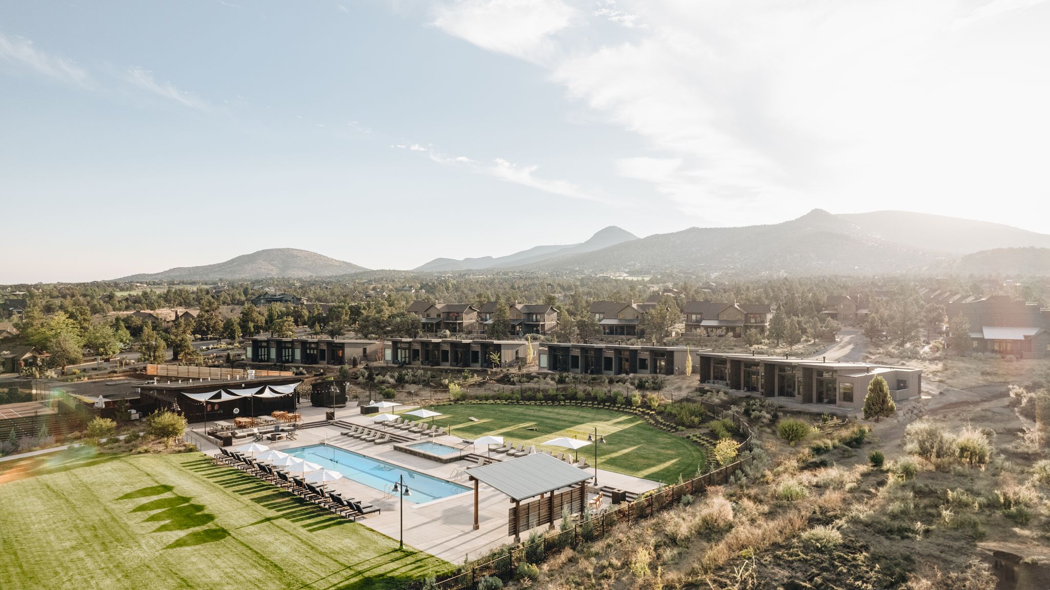 pool and cabins with mountains in background