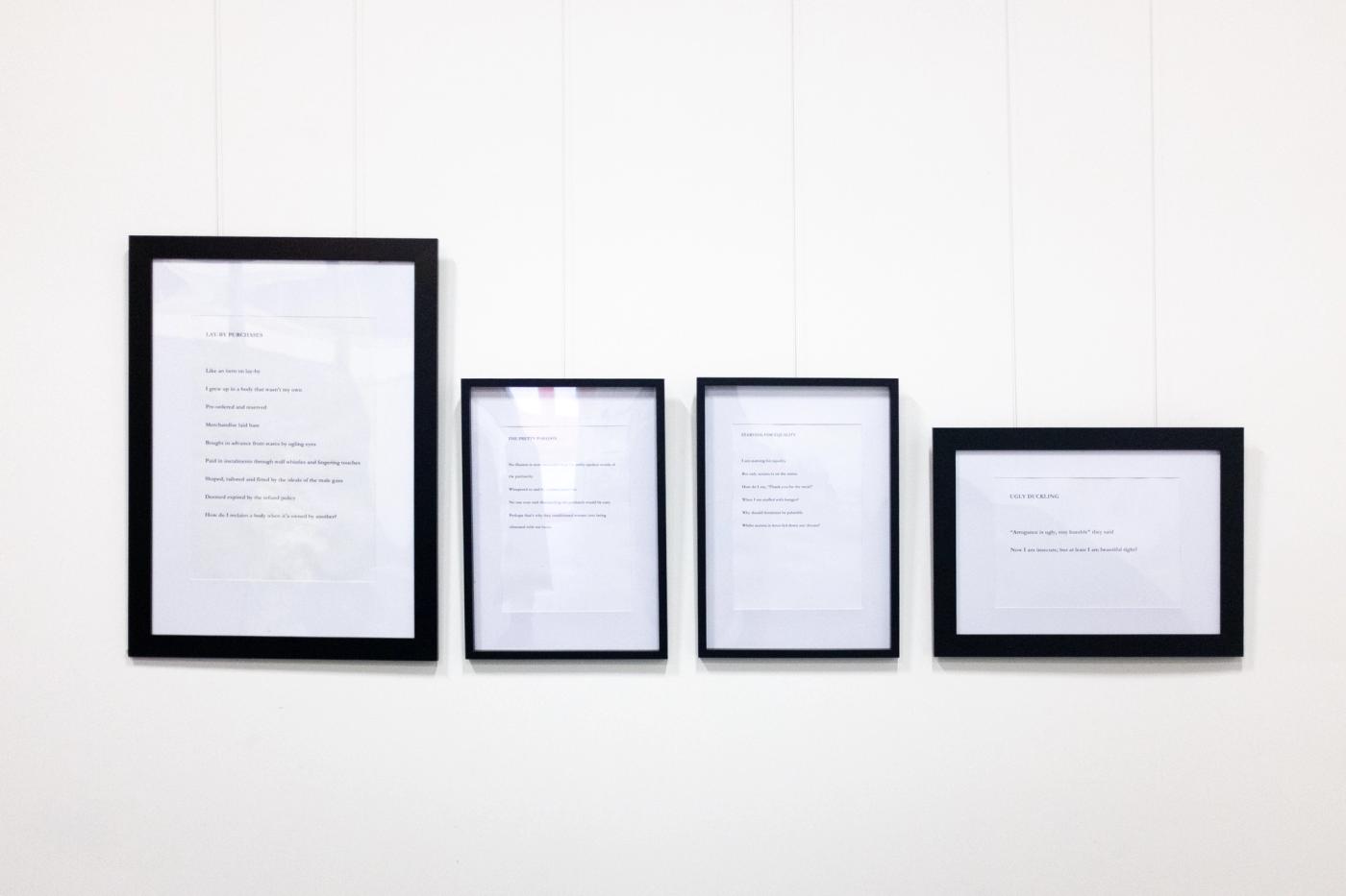 The four poem prints installed at DARE:Disrupt — STARVING FOR EQUALITY is third from left