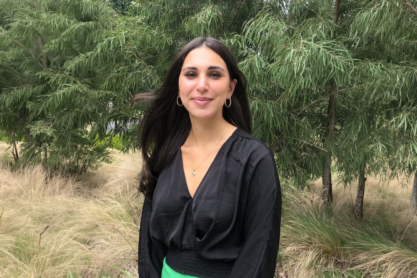 Raquel Fasano standing among native grasses and trees