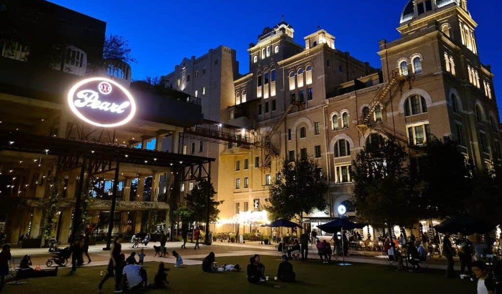 People sitting on the lawn at the plaza at Pearl in San Antonio