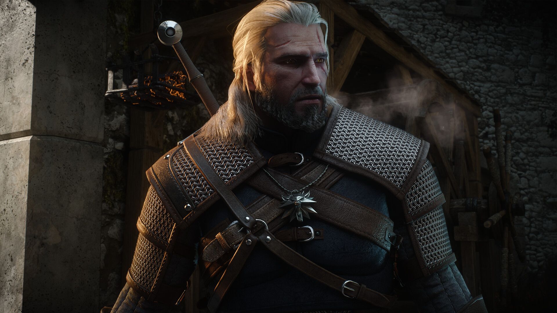 Geralt of Rivia in a chainmail and leather armour set standing in a stone village street