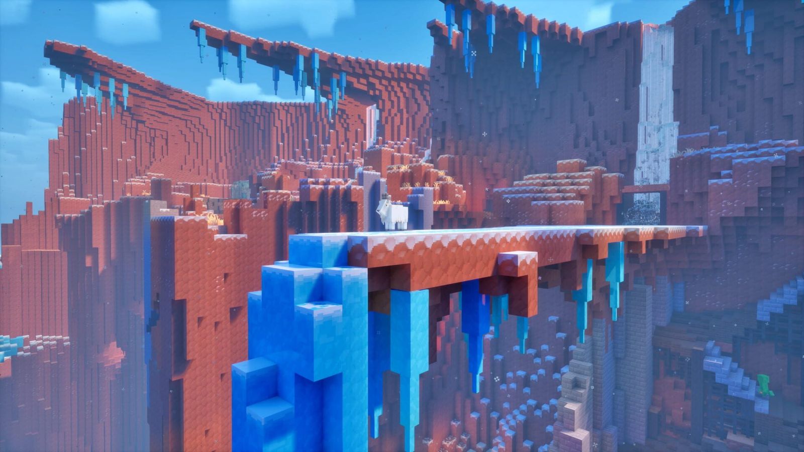 A red rock canyon in Minecraft Dungeons II with an icy bridge, frozen waterfalls and blue ice blocks